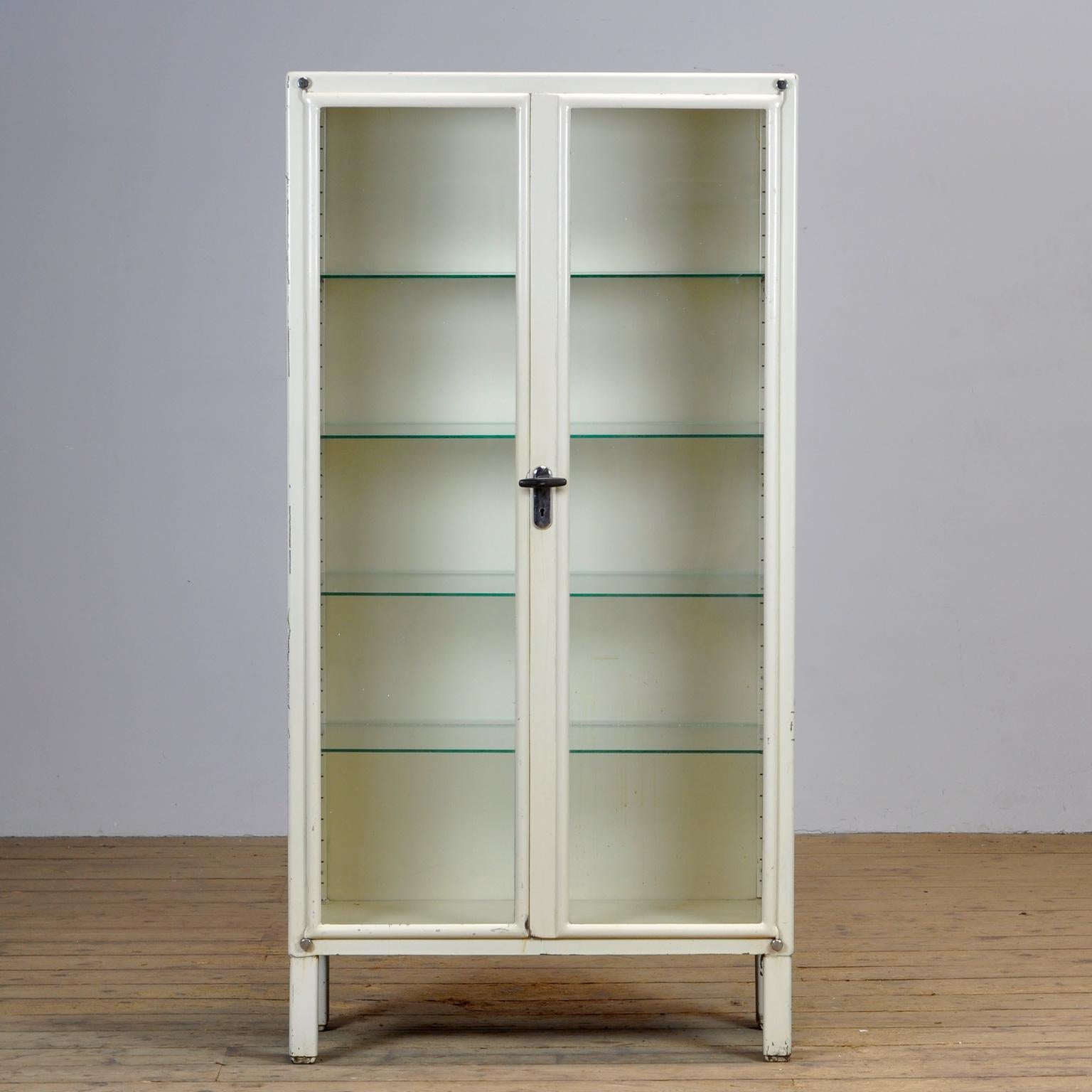 Medical cabinet from Czechoslovakia, produced by Kovona circa 1950. With four new adjustable glass shelves.