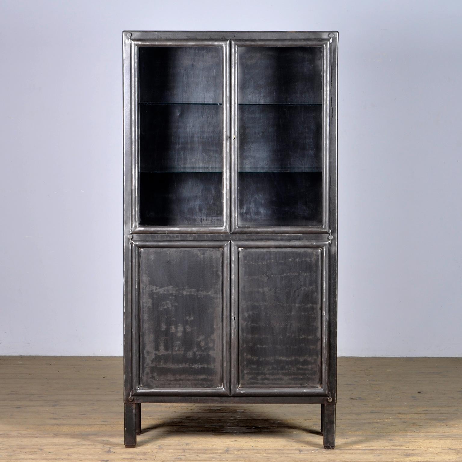 Medical cabinet from czechoslovakia, produced by kovona circa 1950. With two adjustable shelves in the top part and one shelf in the lower part. The cabinet has been stripped from its paint to the metal.