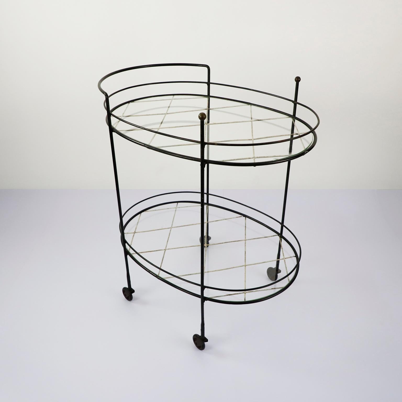 Circa 1960. We offer this iron metal serving cart, fantastic design with brass accents.