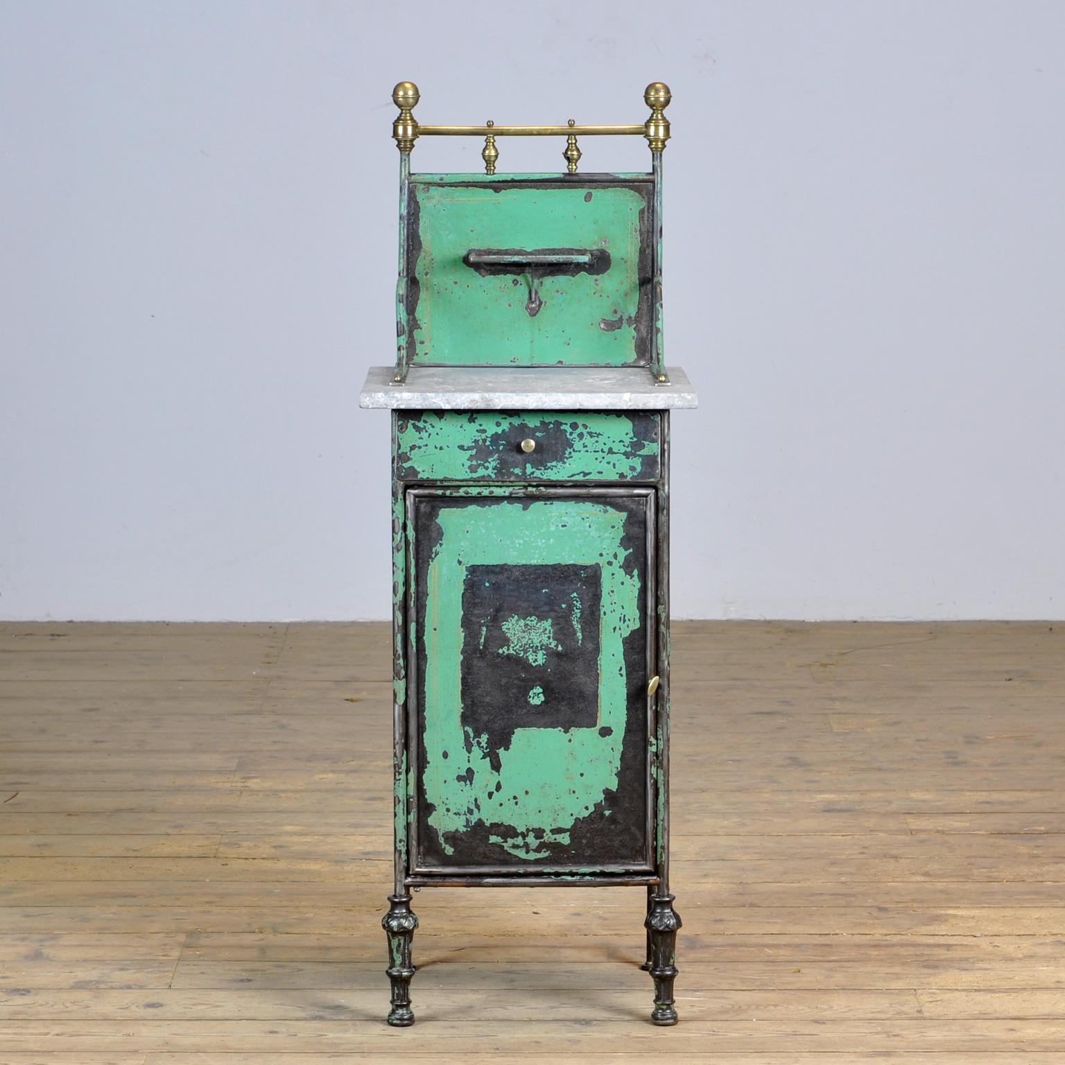 Iron hospital bedside cabinet with a marble top and nice brass details. With the original green paint with fine yellow details. Produced in the 1890s in Germany.
