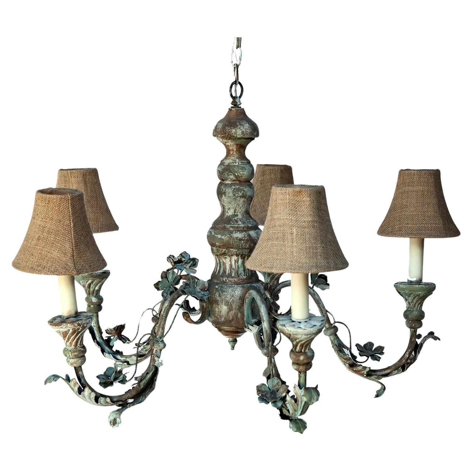 Five Arm Greige Metal Chandelier with Fluted Wood Cups.
Vintage Italian rustic five arm wood & metal chandelier. Metal Floral arms with walnut tone wood base & candle holders. European faux wax candle holders.
Height including the chain is 32