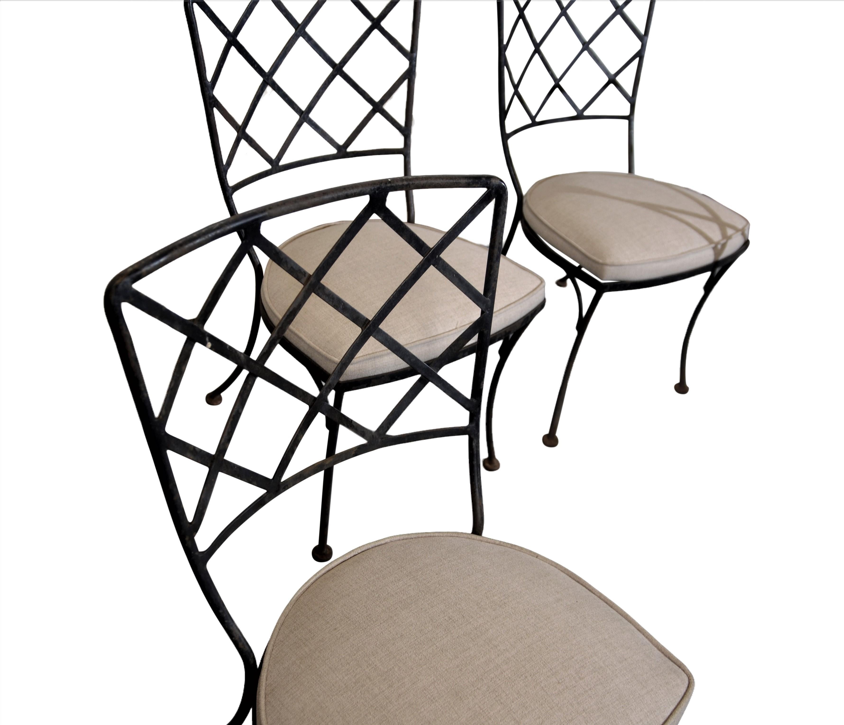 1970's iron patio chairs. The seats are recovered in a fabric that can be used outdoors and indoors.