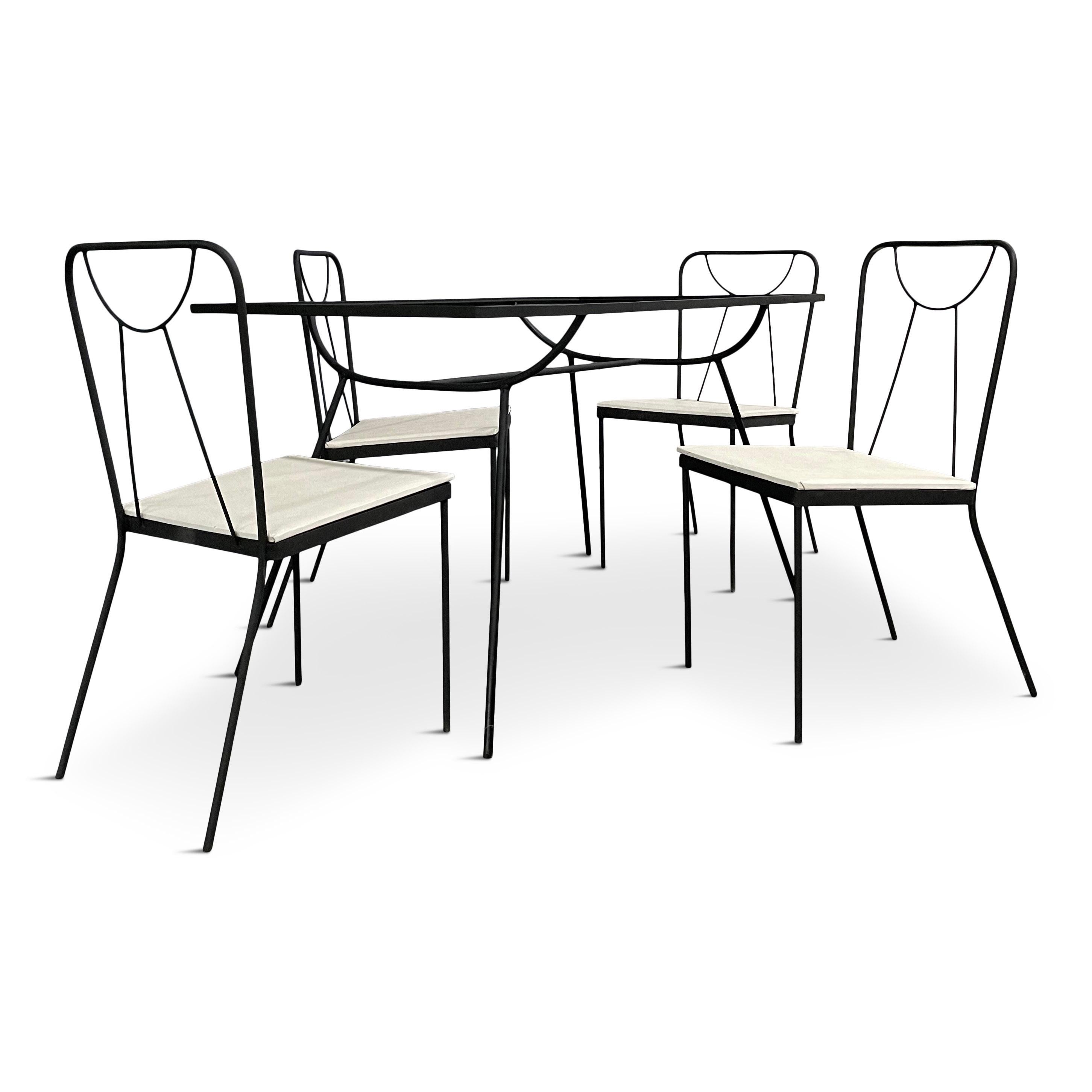 Very cool iron table and four chairs that are the essence of mid century design. This table has a brand new custom made piece of glass; seats can be reupholstered with COM.