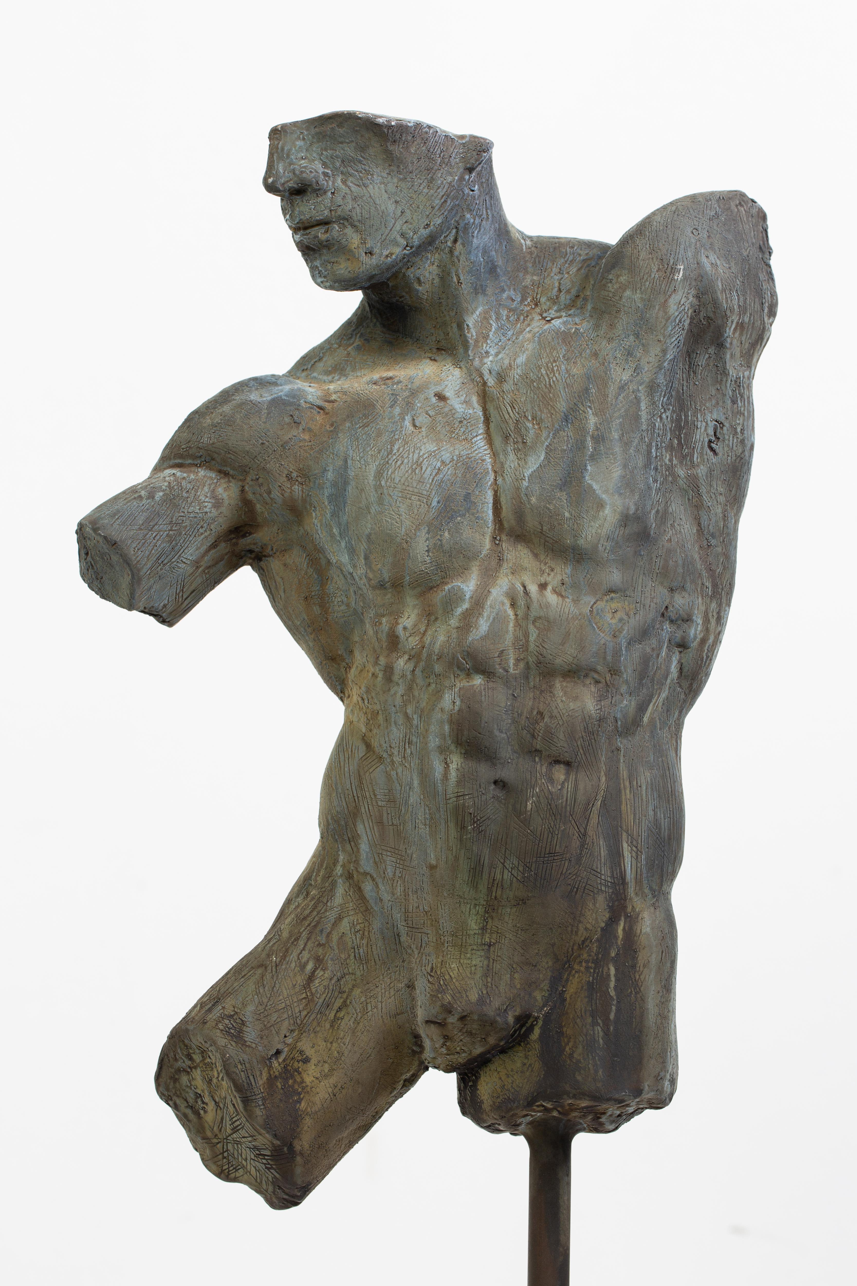 This is an extraordinary bronze sculpture of a Classic male nude fragment by artist Dean Kugler with a verdigris patina.  Attention to detail and complete understanding of the human figure are evident. The sculpture is beautifully custom mounted on
