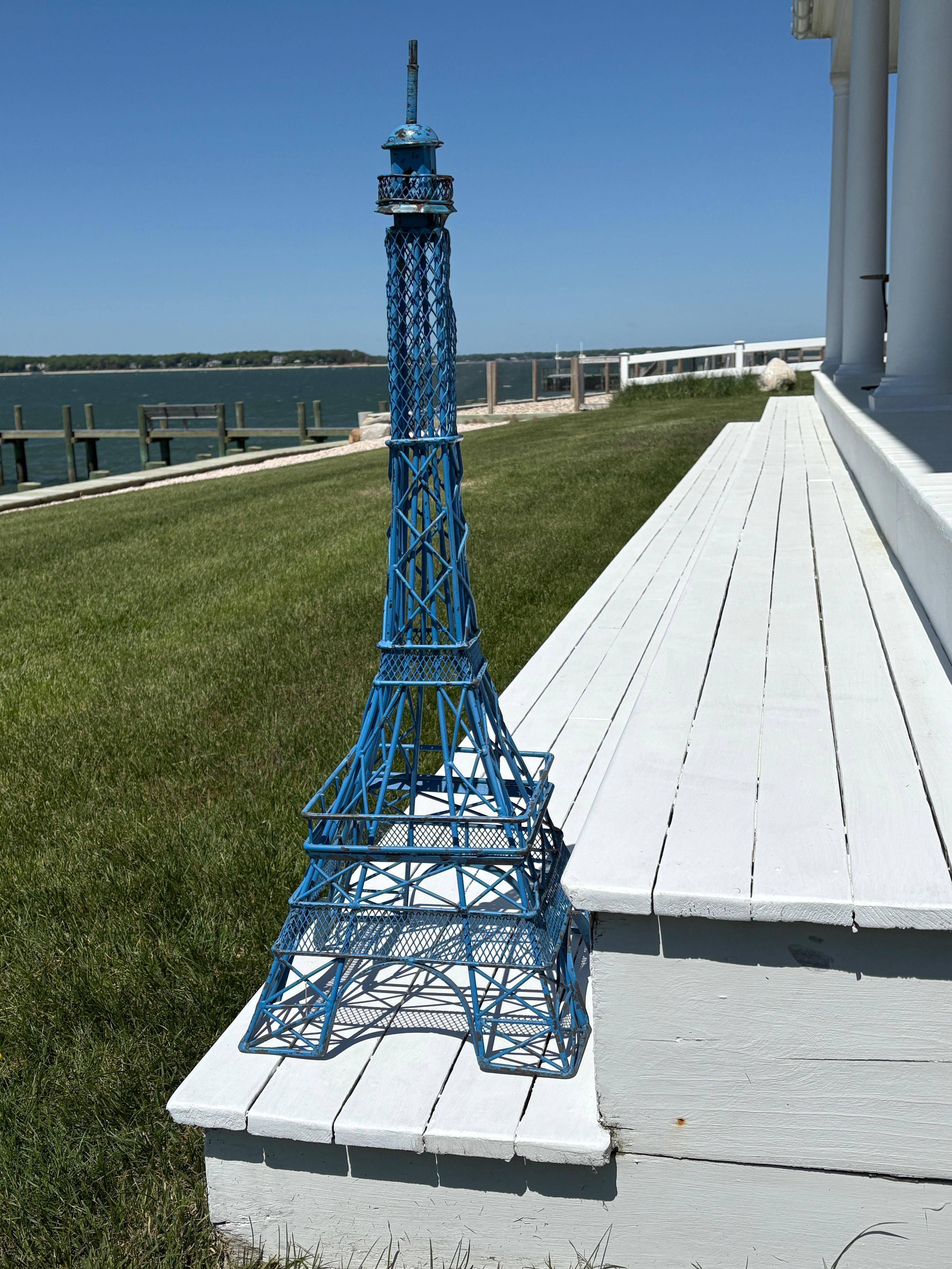 Just a wonderful decorative and charming vintage statue or model of the iconic Eiffel Tower in Paris. For some, it’s great memories or dreams of Paris. It’s made of wrought iron and hand crafted with lots of intricate details and painted blue. Lots