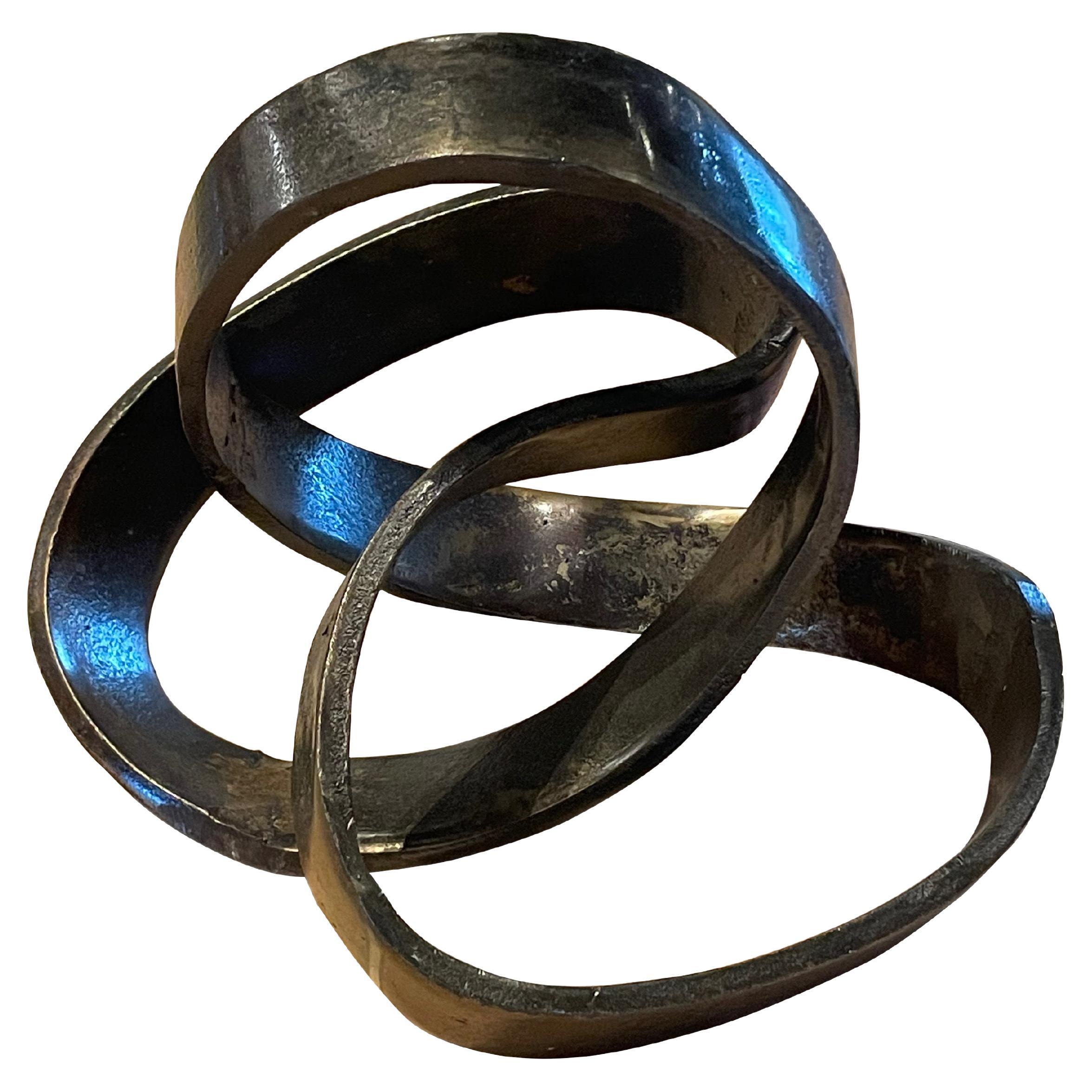Contemporary Chinese iron ribbon sculpture.
Single band of polished iron bent and shaped to form free floating ribbon sculpture.