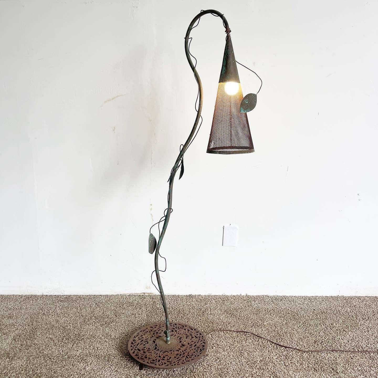 Incredible vintage hand made iron floor lamp. Shade is a metal sheep making a cone around the light which hangs from the stem which has a sculpted vine.