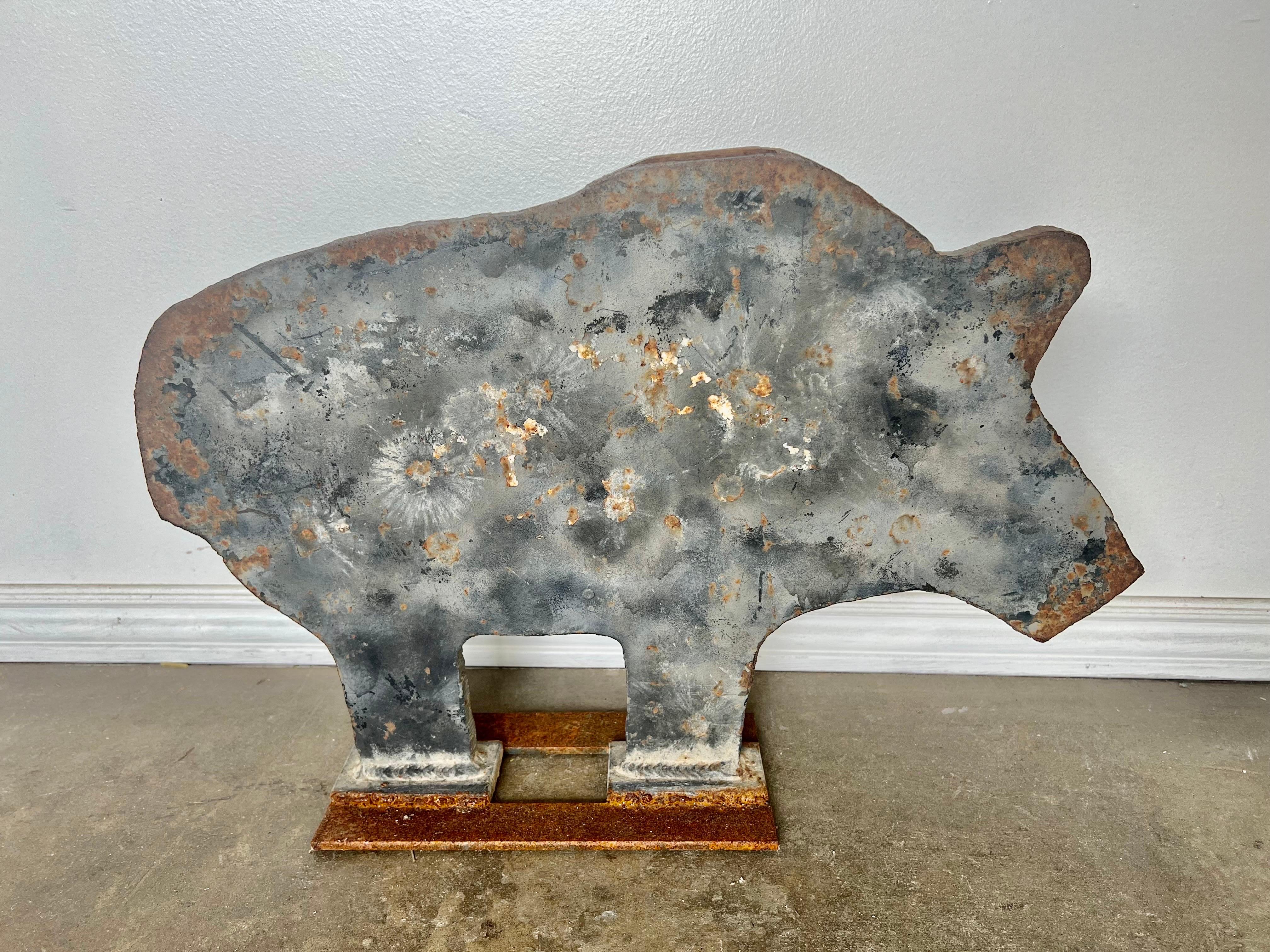 Unique shooting target made from cut steel and iron in the shape of a pig. The piece is quite rusty and weathered from all it's years in use.