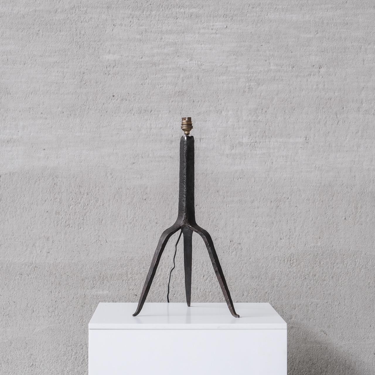 A forged iron table lamp. 

Signed to the underside of one leg. 

France, circa 1950s. 

Good quality, elegant form. 

Since re-wired and PAT tested. 

Location: Belgium Gallery. 

Dimensions: 49 H x 28 W x 26 D in cm. 

Delivery:
