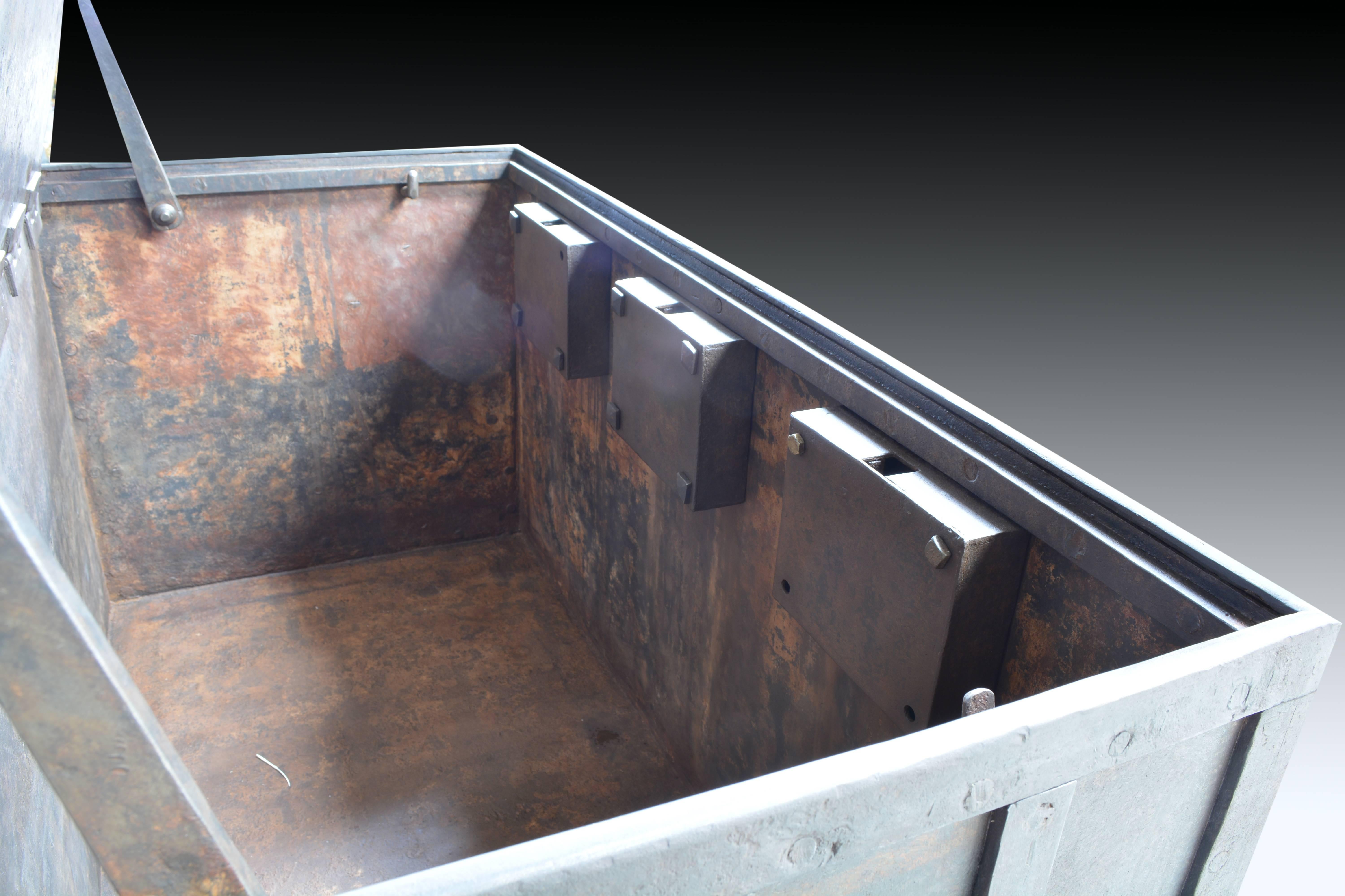 Iron box, 19th century. With manufacturer mark on lid. Ark of flow with the latticed fronts in grid and two handles on the sides and another one on the lid. Three key locks are hidden by rotating tabs and have two bars inside to keep it open. These