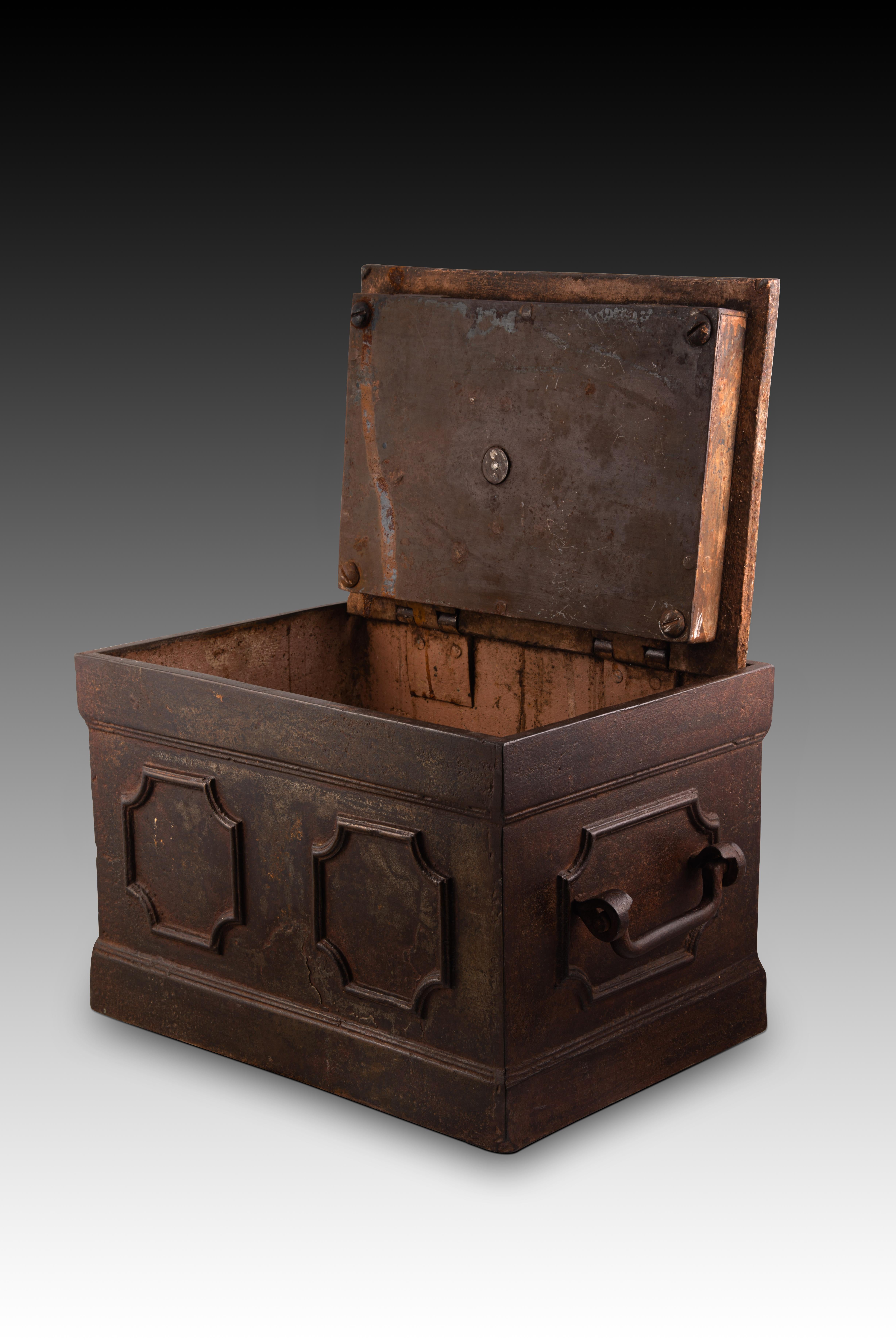 Safe box. Iron. XIX century. 
Rectangular safe made of iron, with a rectangular base, two handles on the sides and classicist-influenced molding decorations on the fronts and top. It opens from the upper area with a door with two hinges, which also