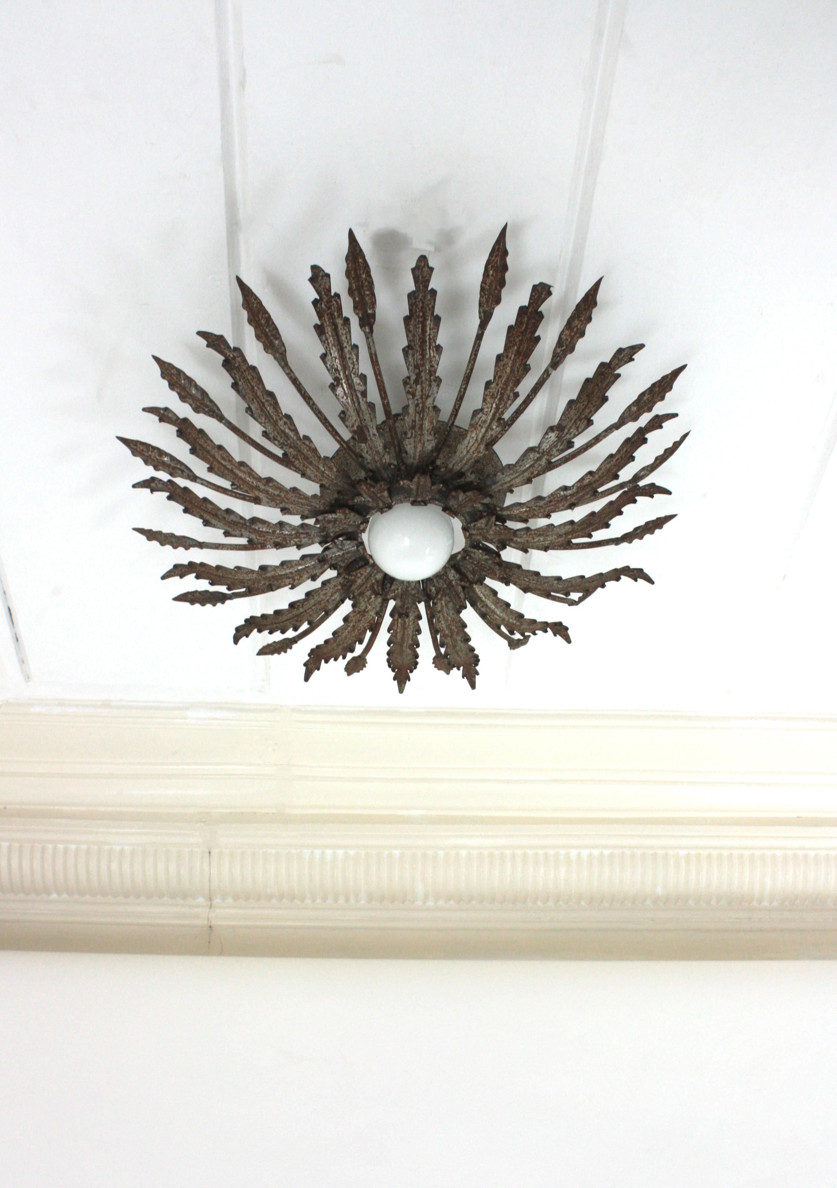 Brutalist Iron Sunburst Ceiling Light Fixture with Leaves Design and Rusty Patina For Sale