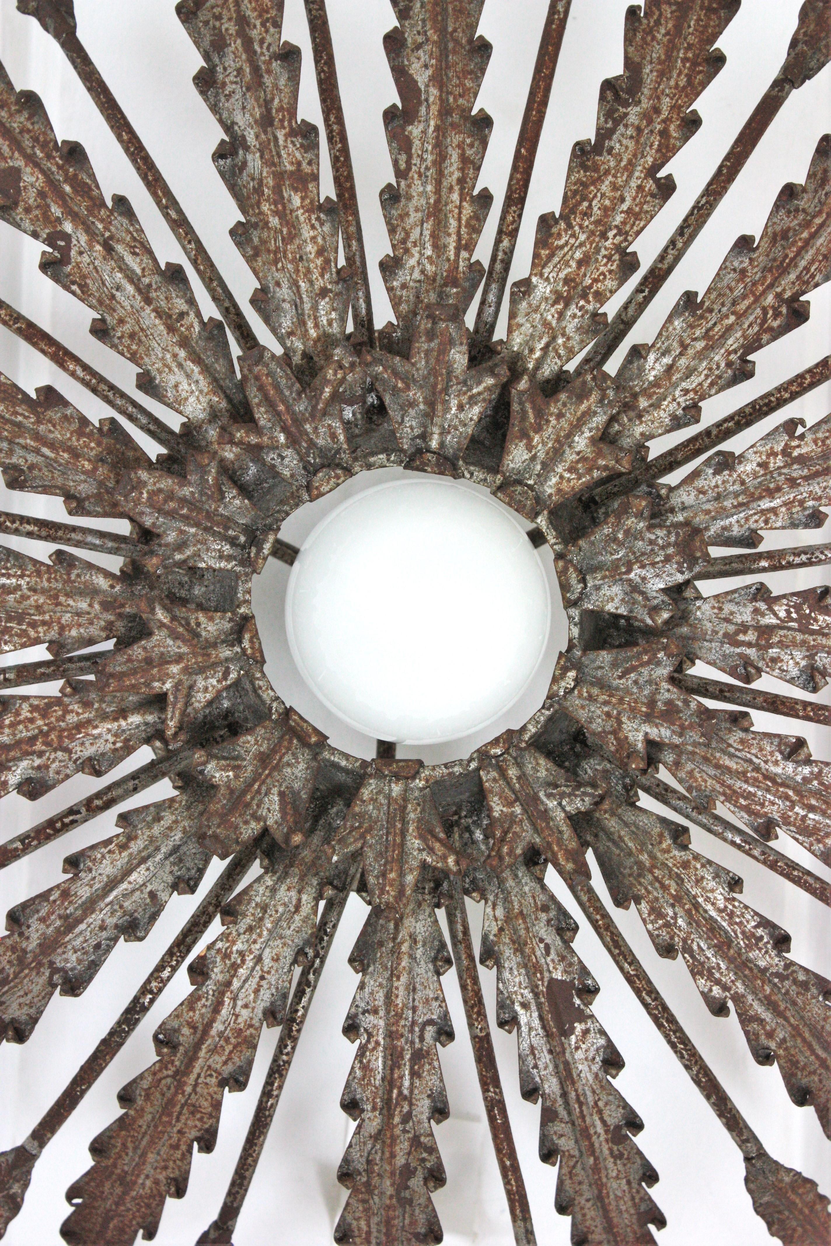 Spanish Iron Sunburst Ceiling Light Fixture with Leaves Design and Rusty Patina For Sale