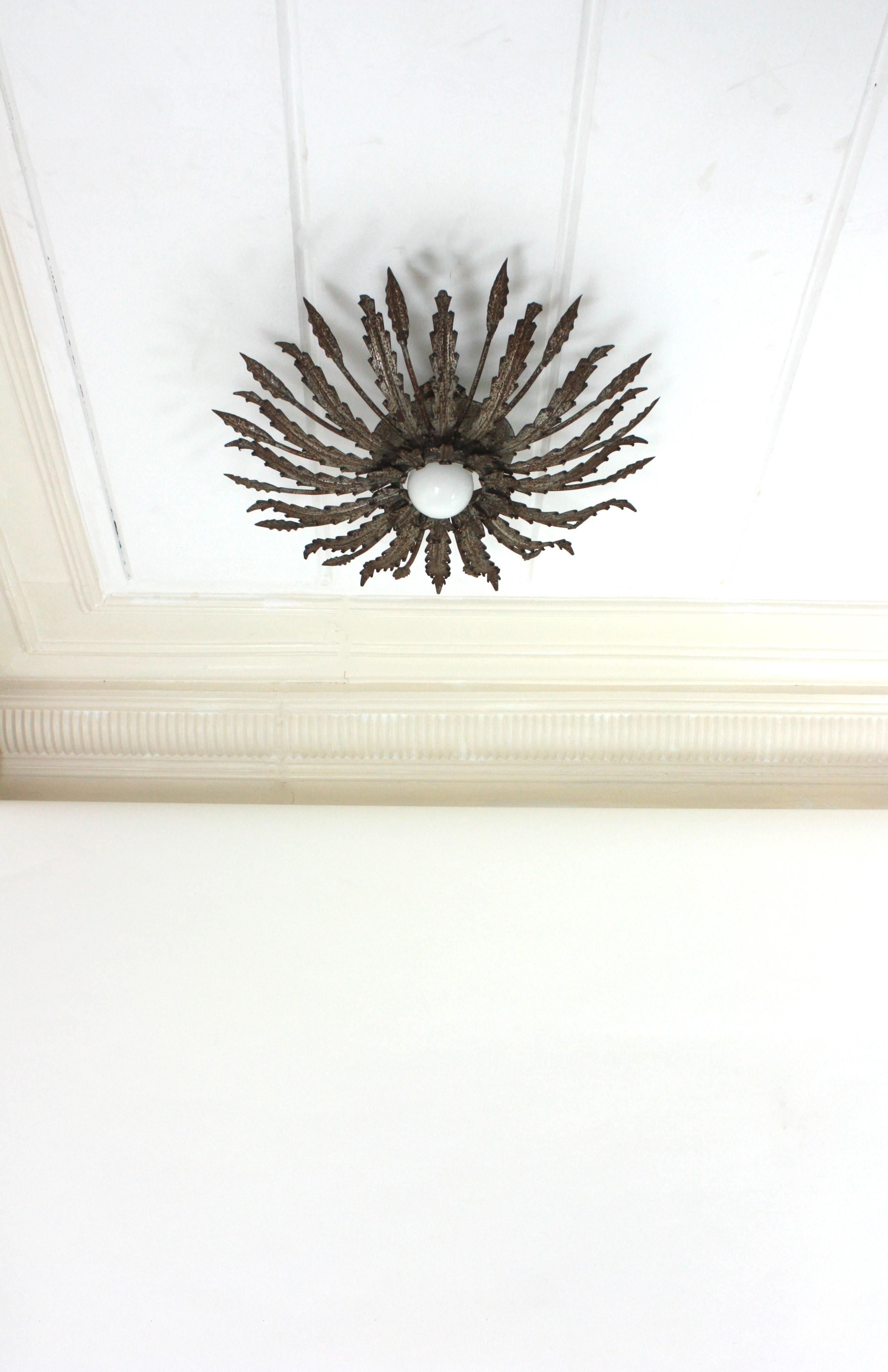Hammered Iron Sunburst Ceiling Light Fixture with Leaves Design and Rusty Patina For Sale