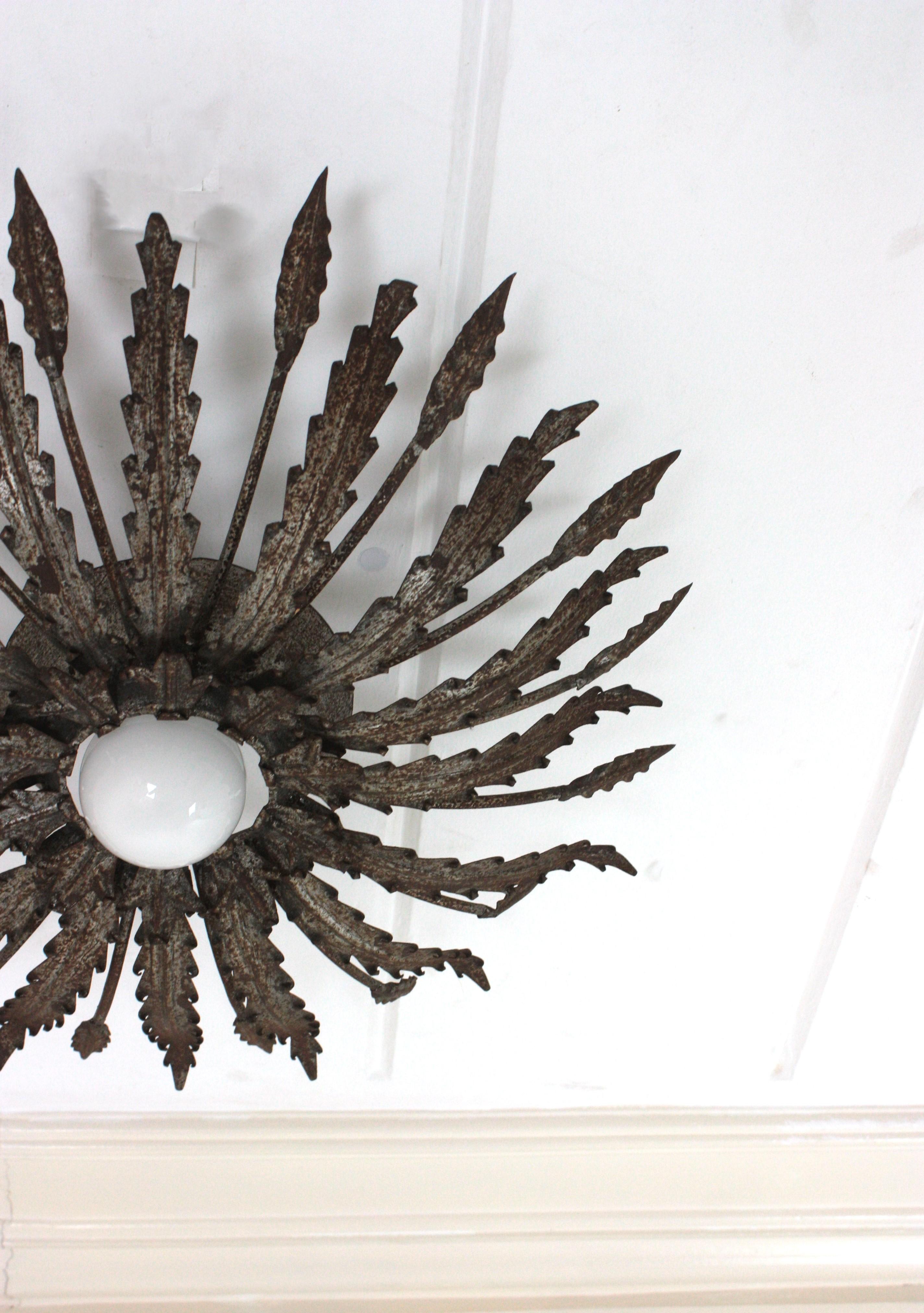 Iron Sunburst Ceiling Light Fixture with Leaves Design and Rusty Patina In Good Condition For Sale In Barcelona, ES
