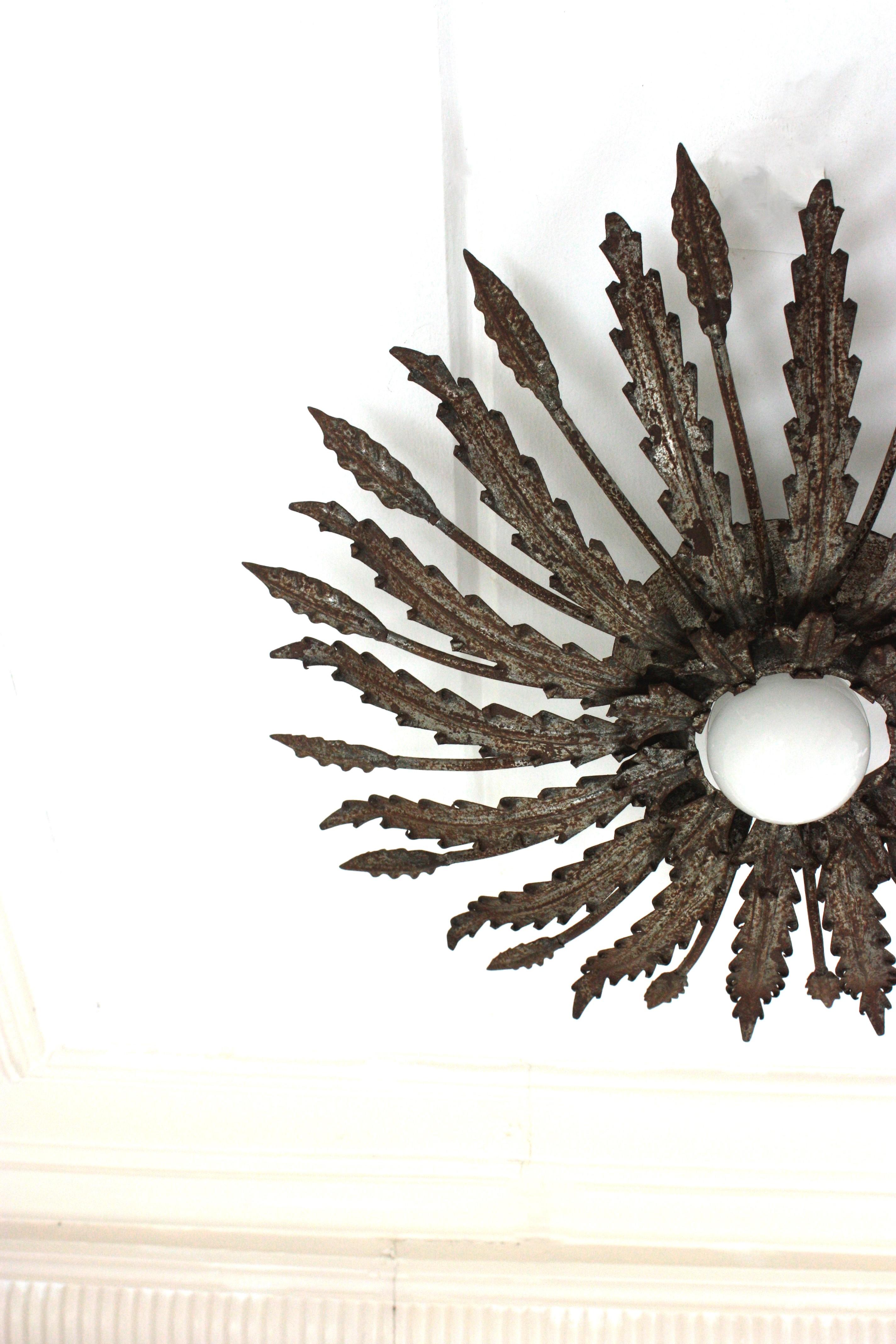20th Century Iron Sunburst Ceiling Light Fixture with Leaves Design and Rusty Patina For Sale