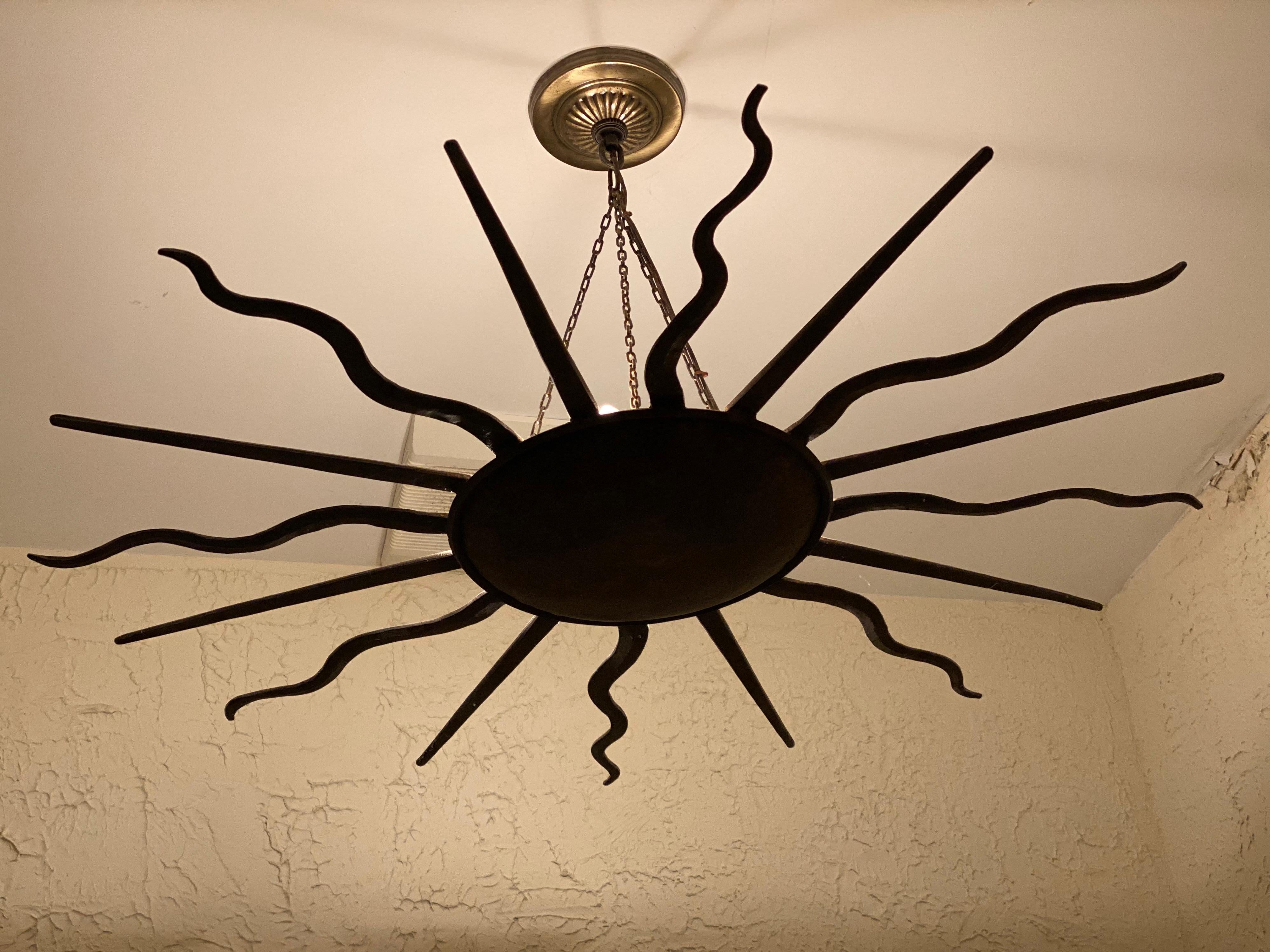 Iron Sunburst Chandelier in Antiqued Bronze Finish, Late 20th Century
When hanging, the chandelier very much reads as a black finish but upon closer inspection it is actually a antiqued bronze finish. A statement piece in a powder room. The four