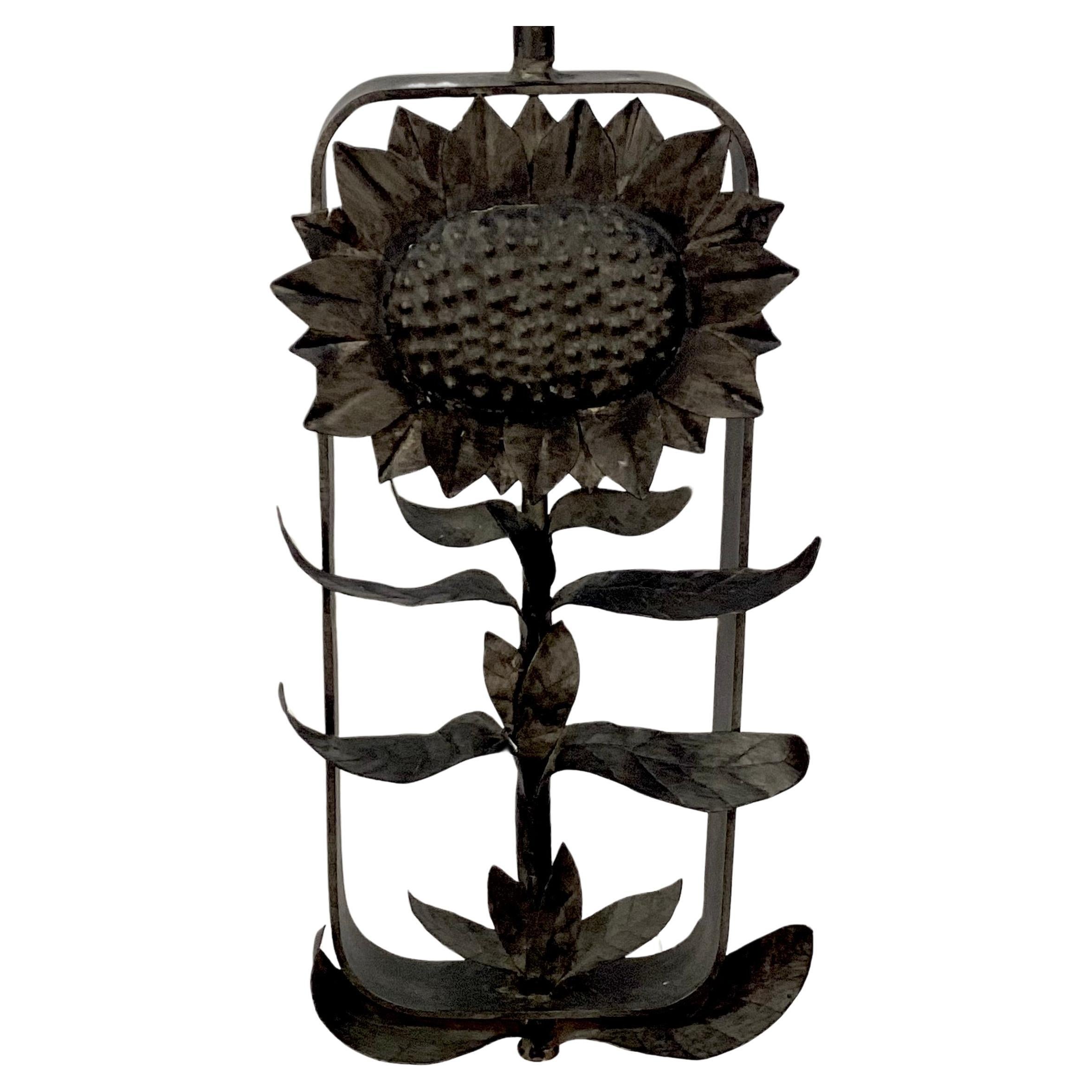 Unique one of a kind iron lamp with base of sculpted into a large sunflower face with stalk and leaves, all on a rectangular clear Lucite base. Lamp features a small sunflower finial to match. Would look great on a porch or in a sunroom, but is