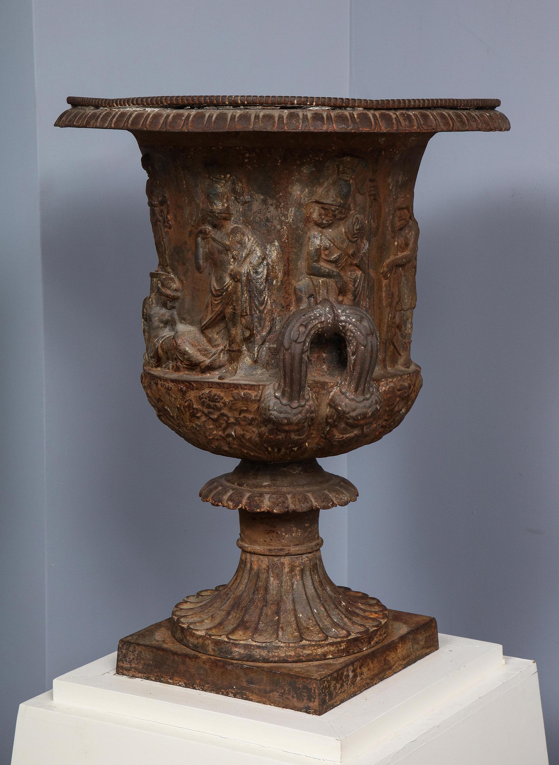 Iron Urn, after the Medici Urn in the Uffizi Gallery

Iron Urn after the Medici Urn in the Uffizi Gallery collection. Having a gadrooned lip, with a mythological bas-relief of a female figure seated below a statue of a goddess on a high plinth,