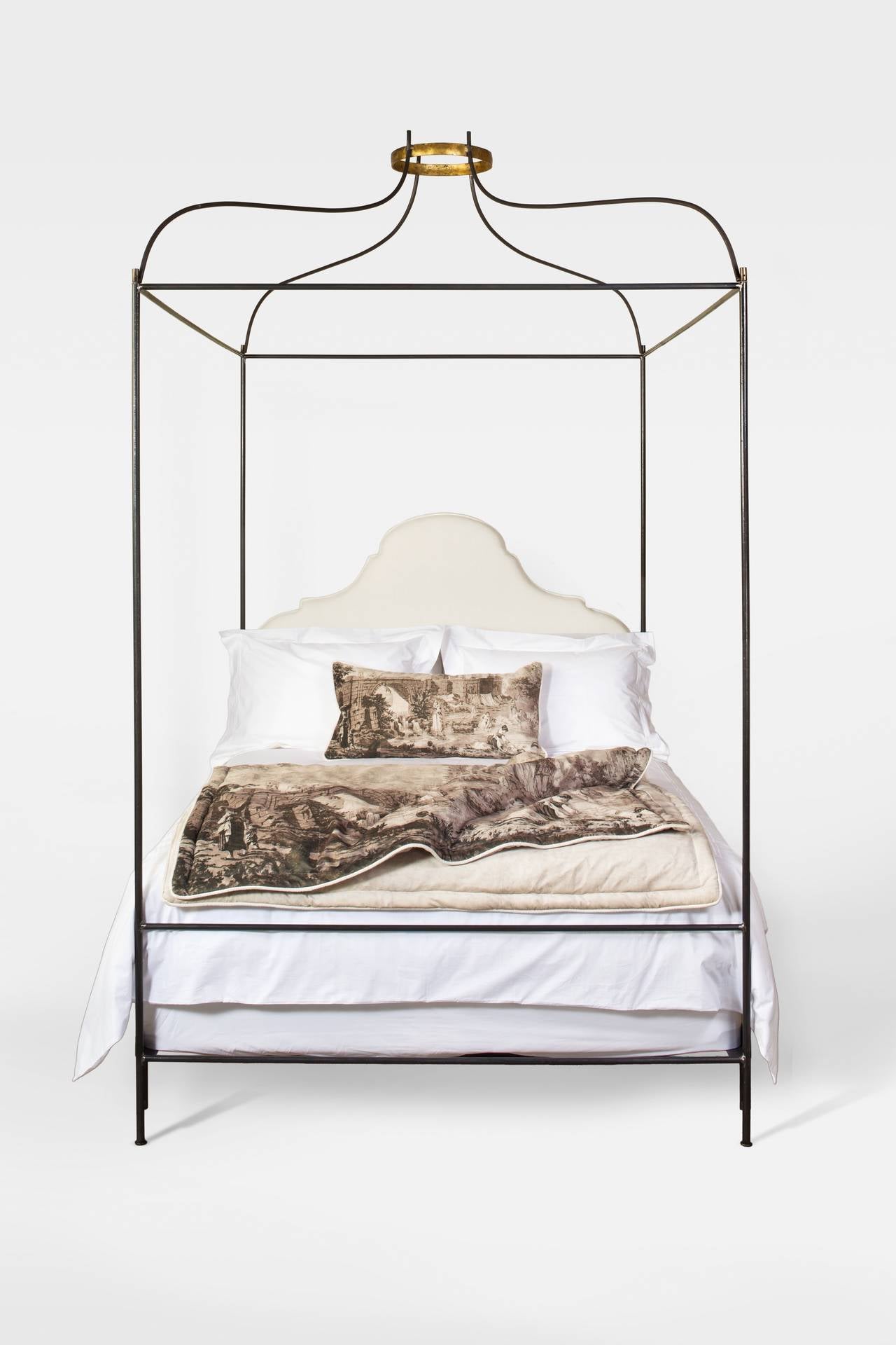 This iron Venetian canopy bed with upholstered headboard from the Tara Shaw Maison collection is one of our most popular custom beds. hand forged gilded or silver leaf crown and small detail at feet. Handcrafted in New Orleans. Standard headboard