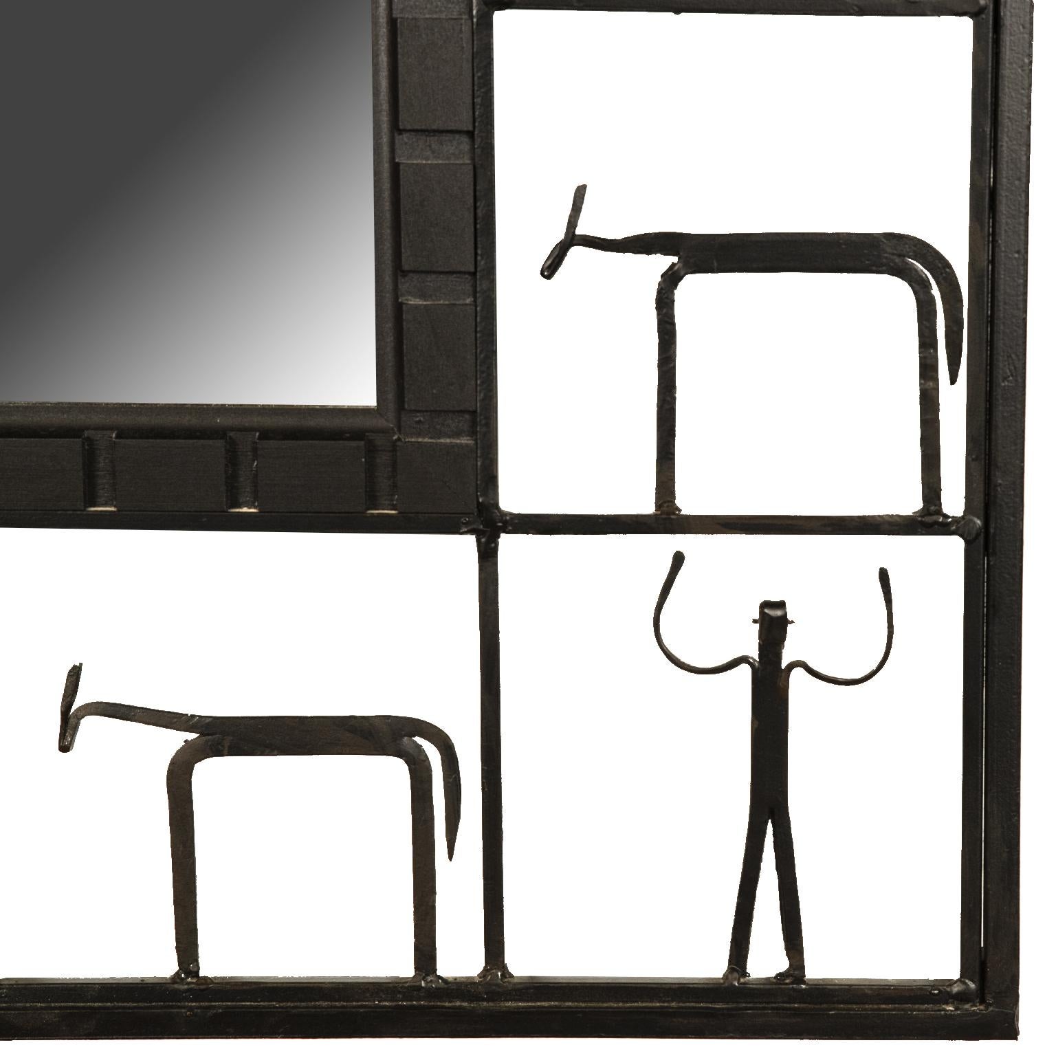 This is a wonderful and whimsical rectangular mirror with an openwork iron frame depicting human and animal forms housing a rectangular mirror. 