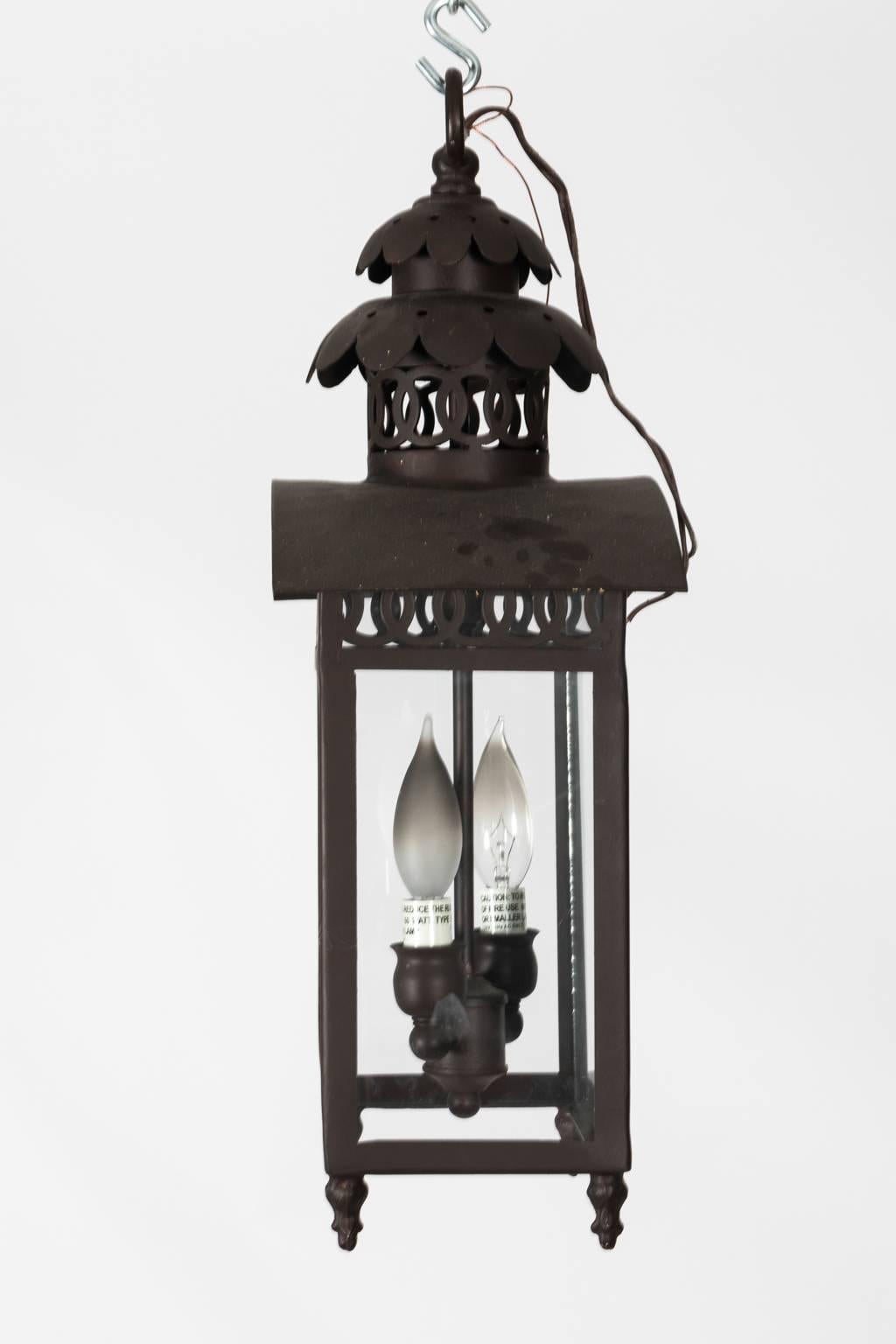 Contemporary black ironware exterior lantern with two lights and disk tracery.
   