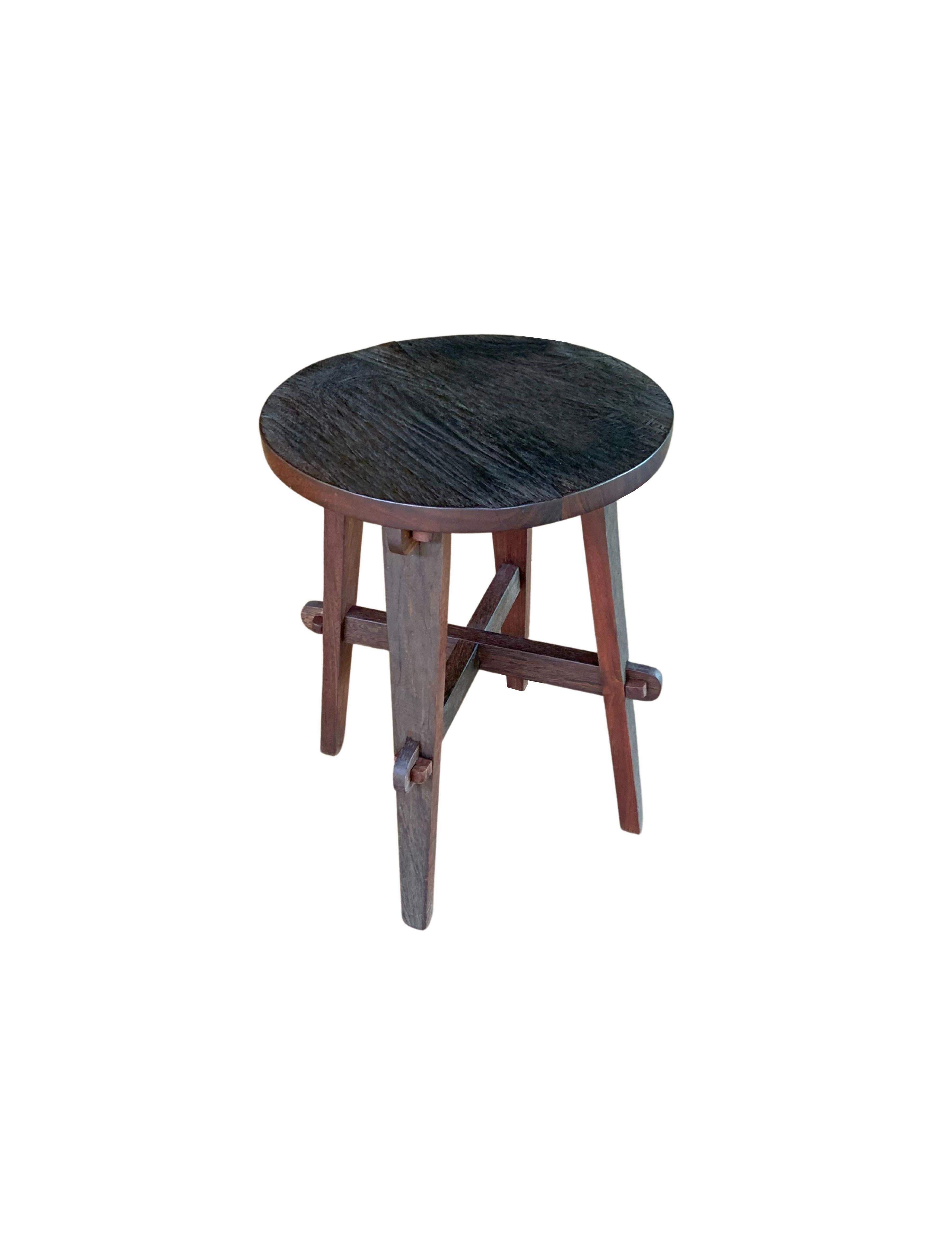 A wonderfully sculptural round stool hand-crafted from reclaimed Ironwood by local Balinese artisans. Its neutral pigment and subtle wood texture makes it perfect for any space. The wood joinery techniques used to secure the legs and struts add to