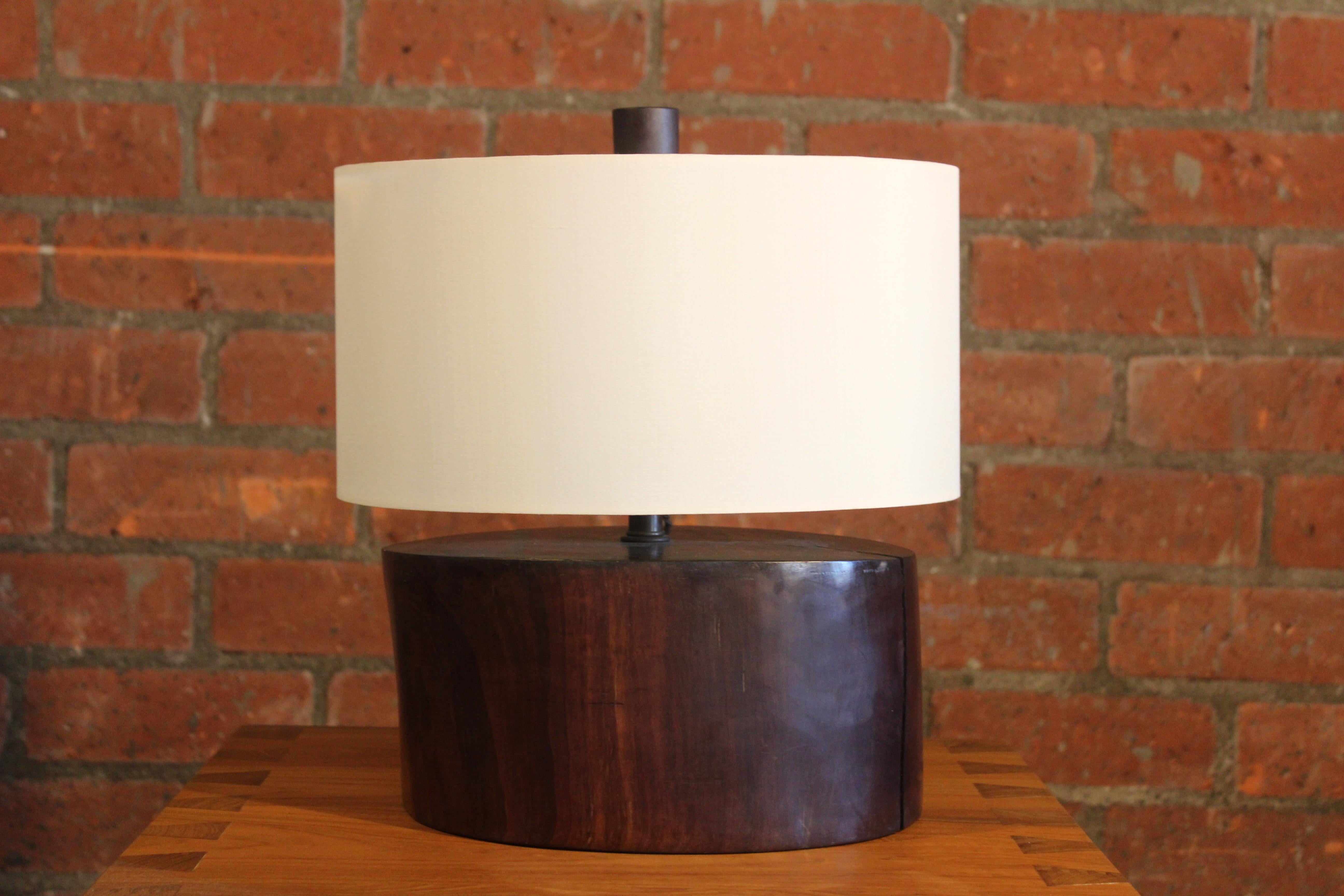 An ironwood stump table lamp, newly French wired and fitted with a custom shade in silk.