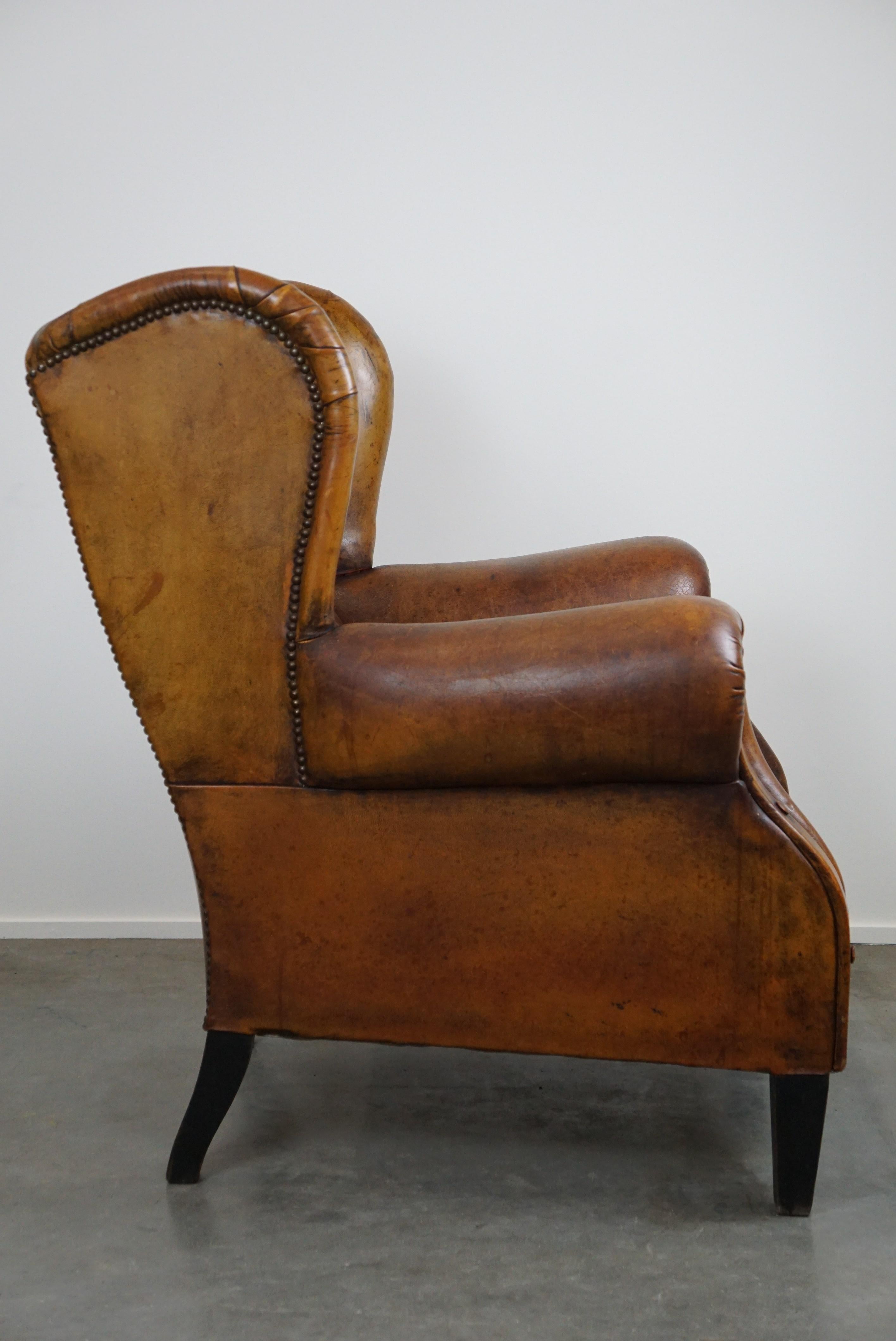 Romantic Irresistible old sheep leather wingback armchair with the most beautiful colors For Sale
