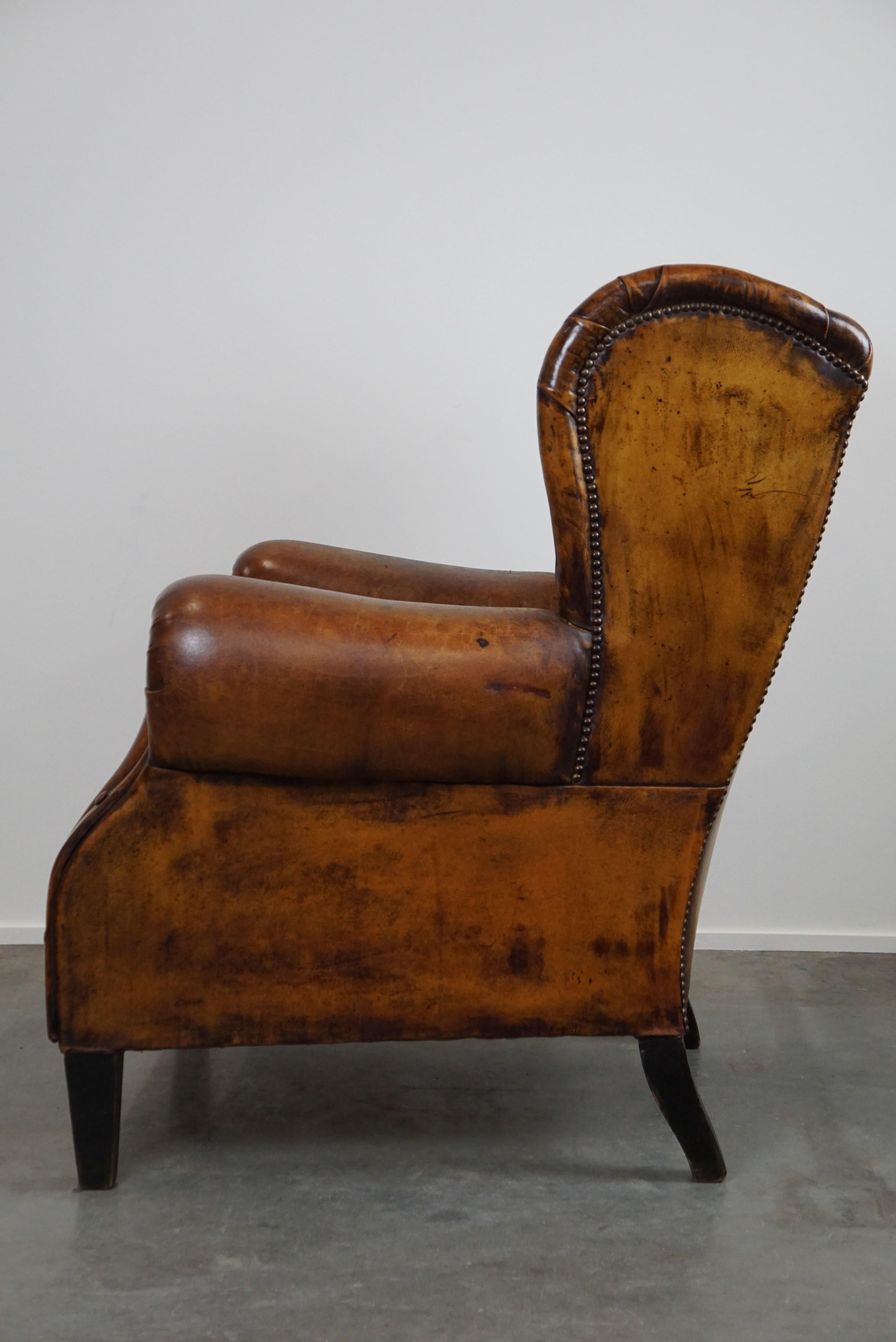 Mid-20th Century Irresistible old sheep leather wingback armchair with the most beautiful colors For Sale