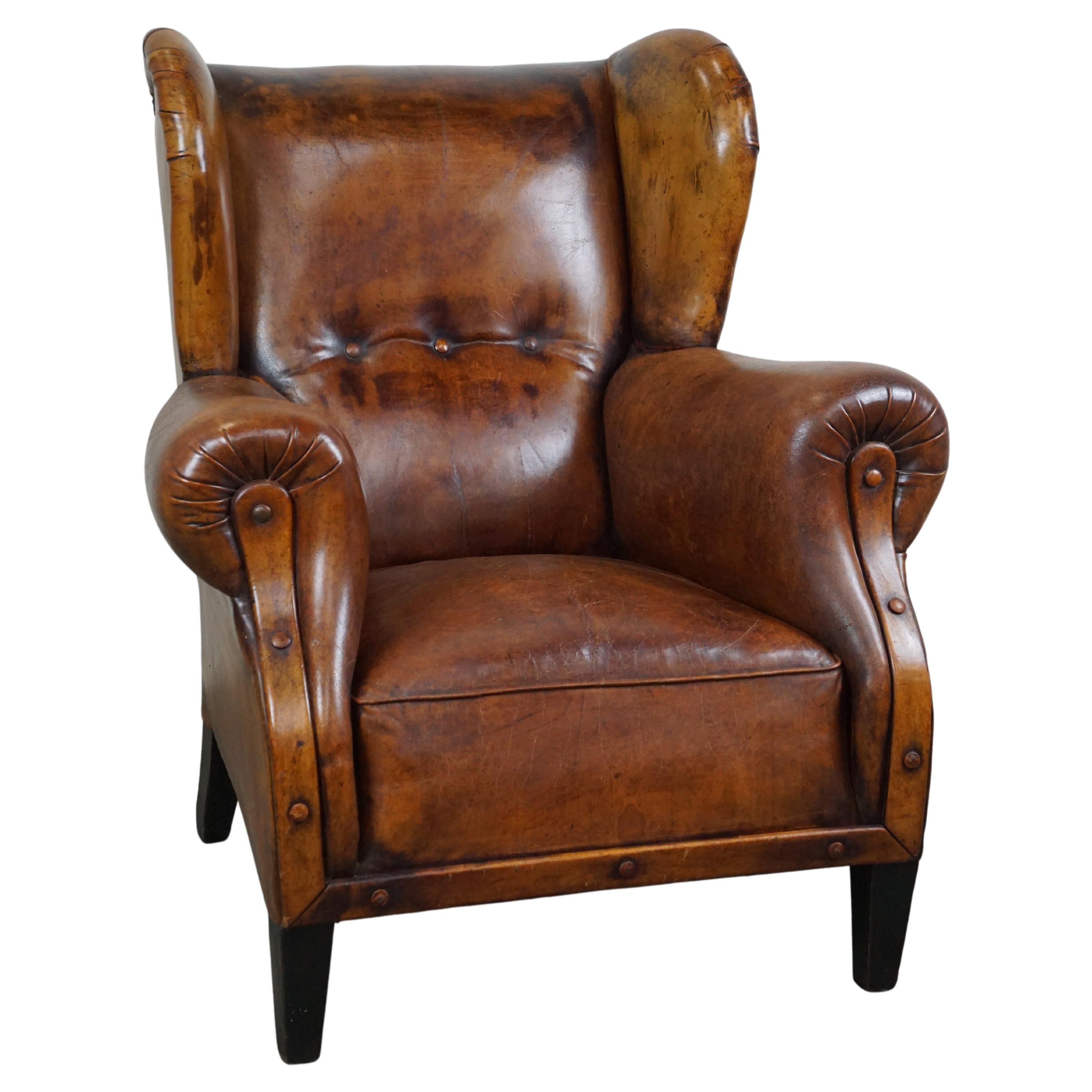 Irresistible old sheep leather wingback armchair with the most beautiful colors For Sale