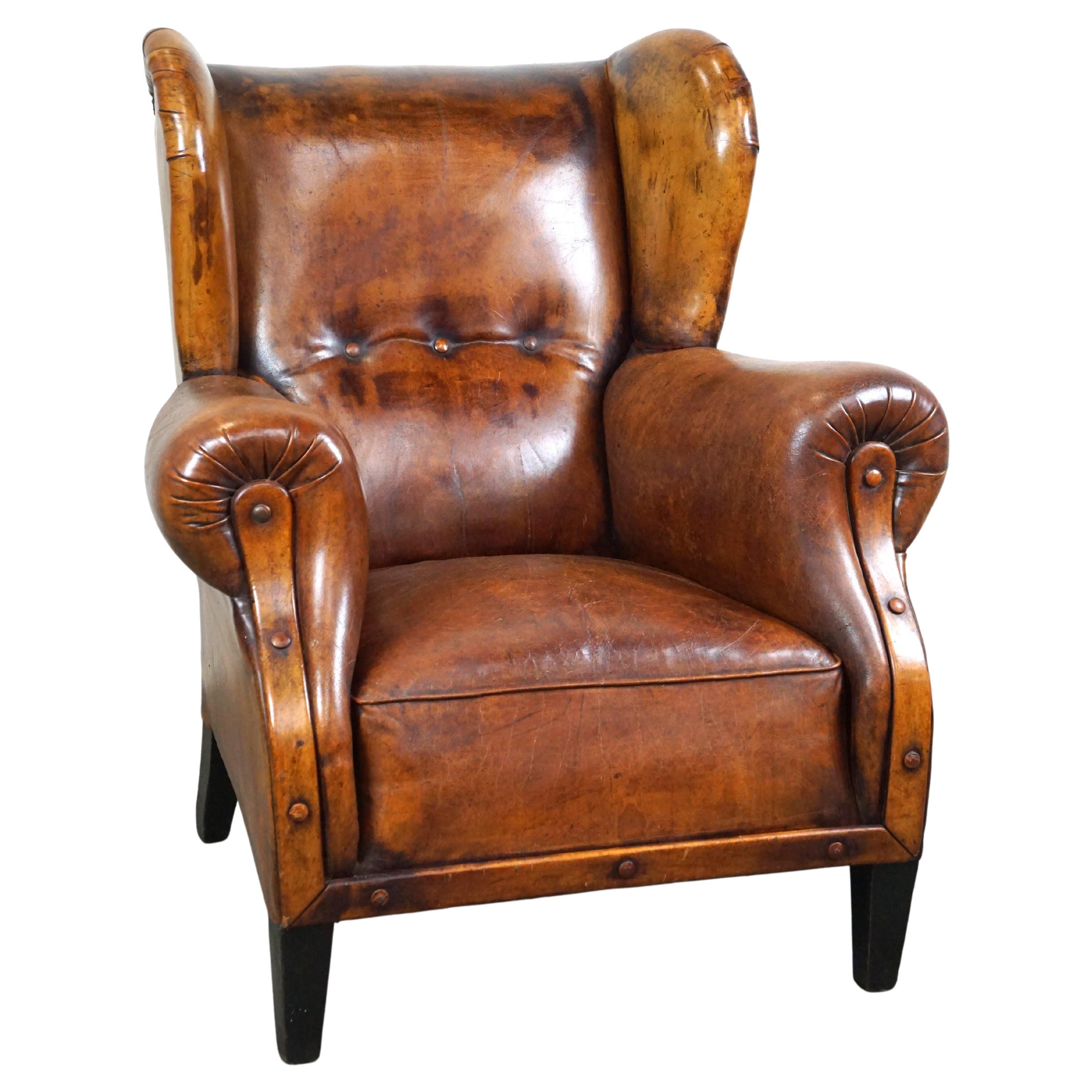 Irresistible old sheep leather wingback armchair with the most beautiful colors