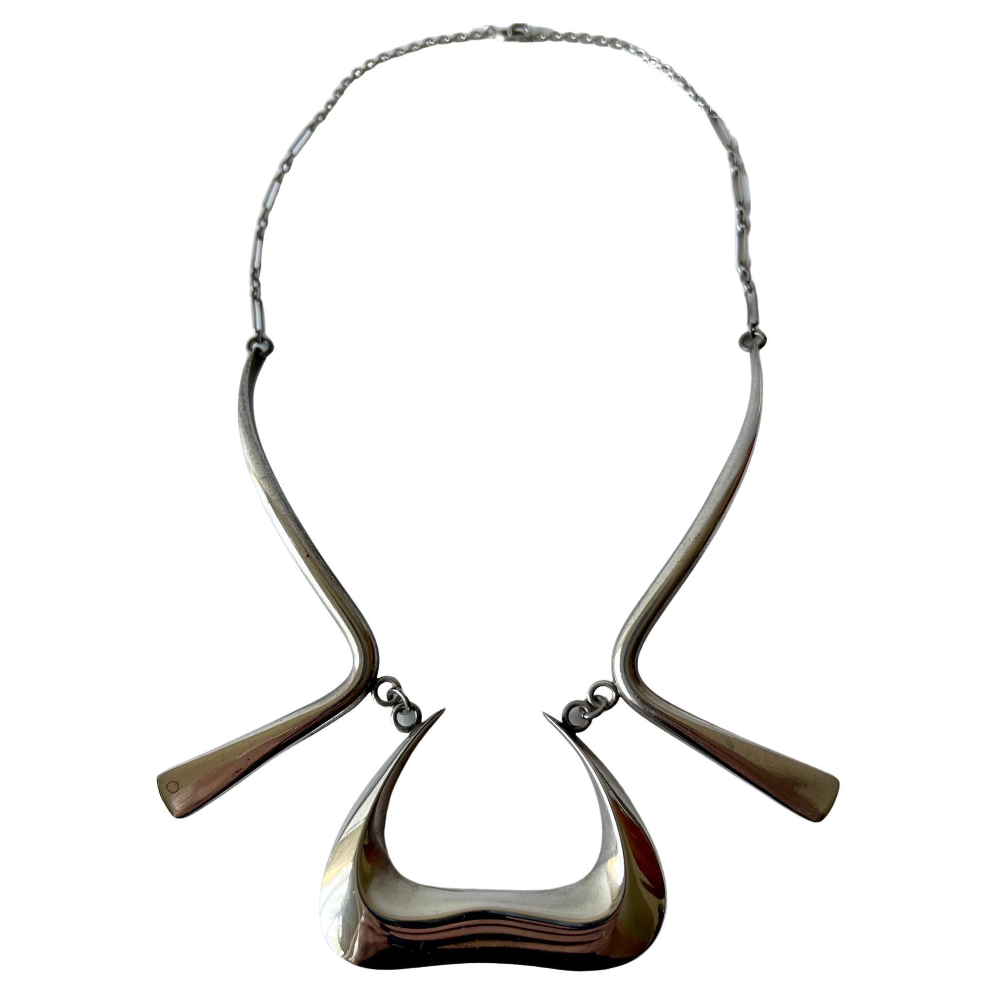 Sterling silver abstract modernist necklace created by Irvin and Bonnie Burkee, circa 1950's.  Necklace has a 17