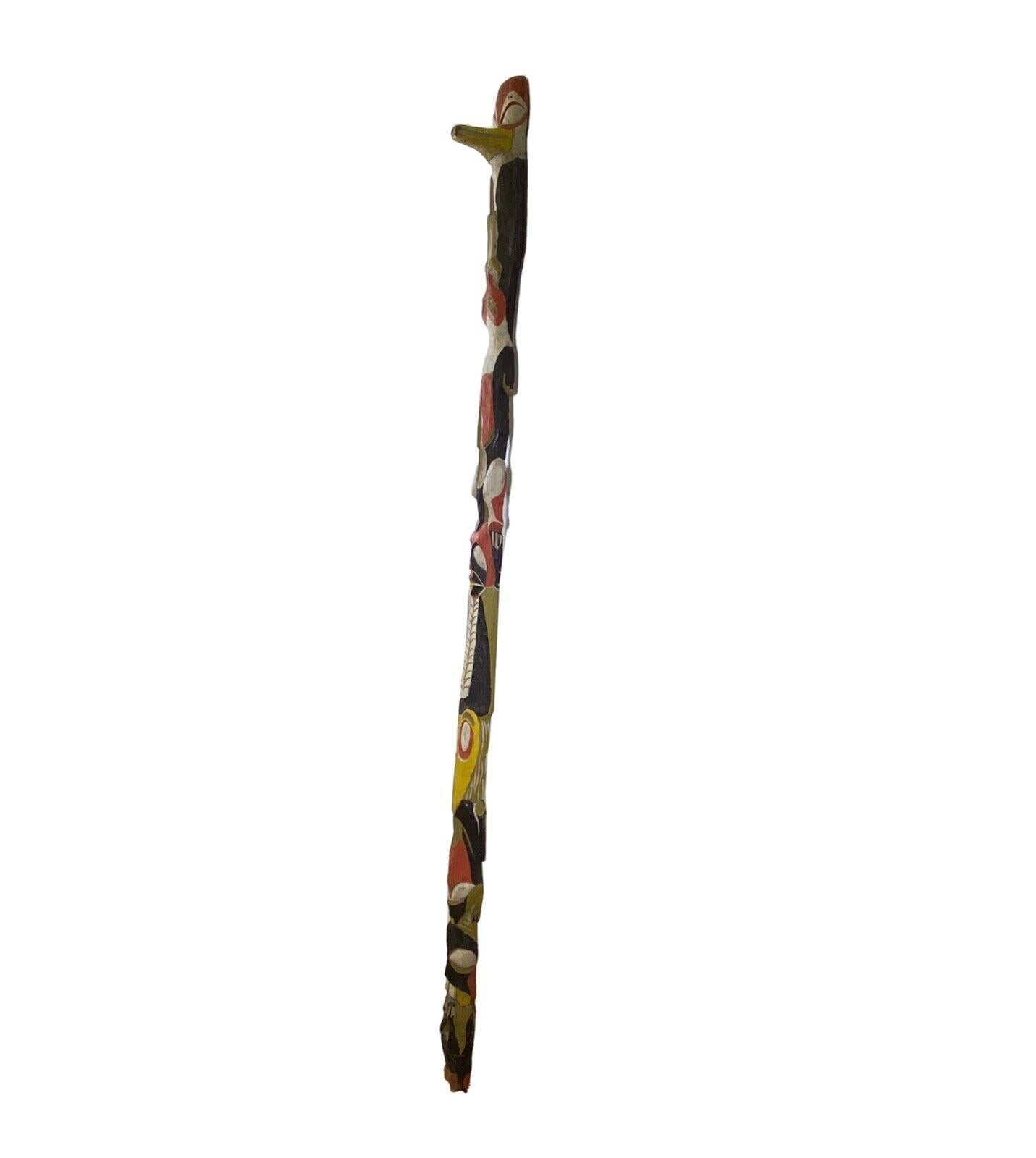A mid century modernist wooden carved totem pole titled “Snowden” by Irving Berg. Identified on tag via the verso. A monumental totem with unique hand carved details that are brightly painted. From a private collection. Dimensions: 84”h x 5”w x 6”d.