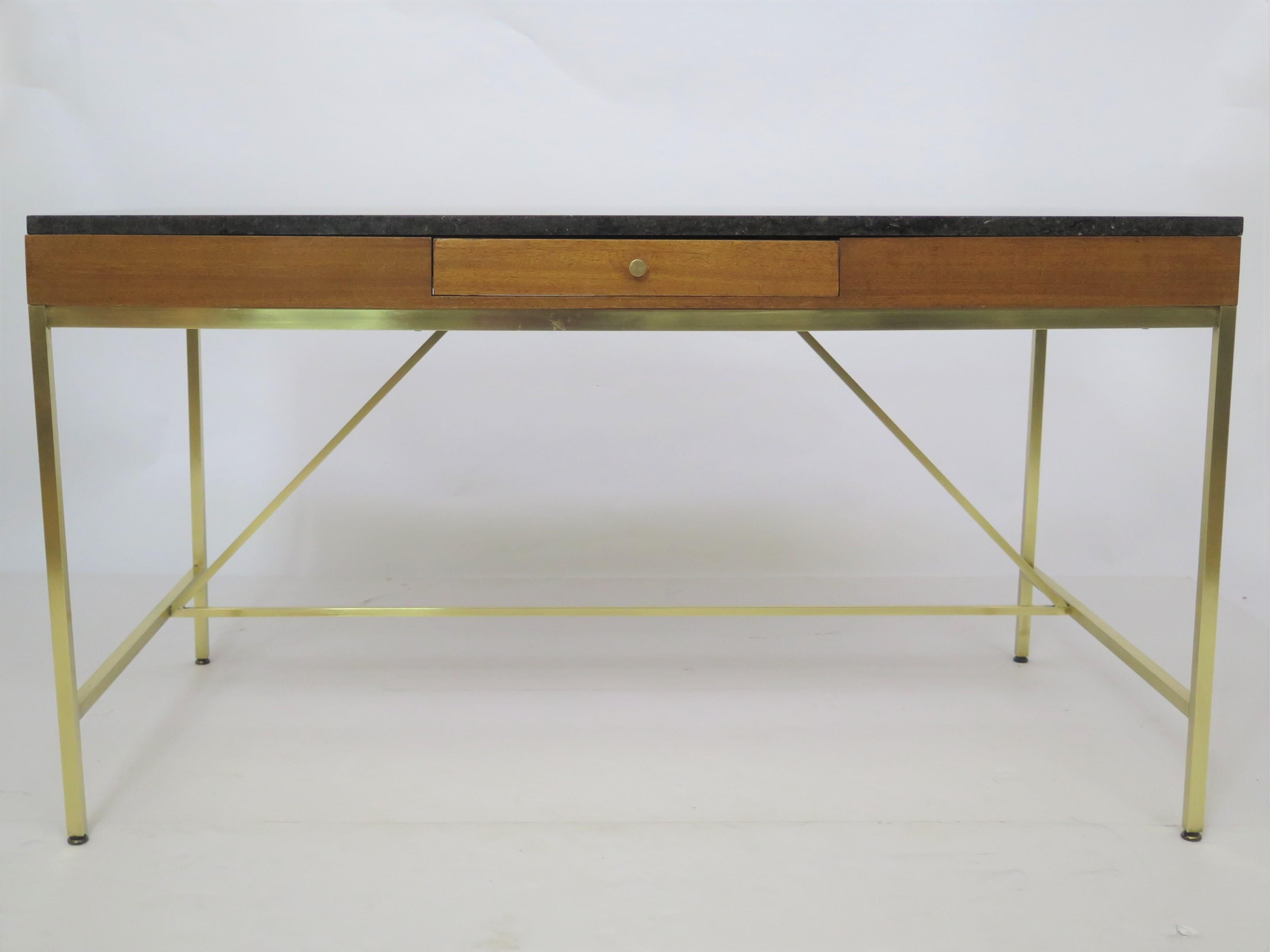 TABLE DESK by American designer Paul McCobb (1917-1969), The Irwin Collection for Calvin Furniture, brass with marble top, in SANDRIFT (mahogany) with RADIO BLACK marble, single drawer and two (2) end slides . Applied brass manufacturer's label in