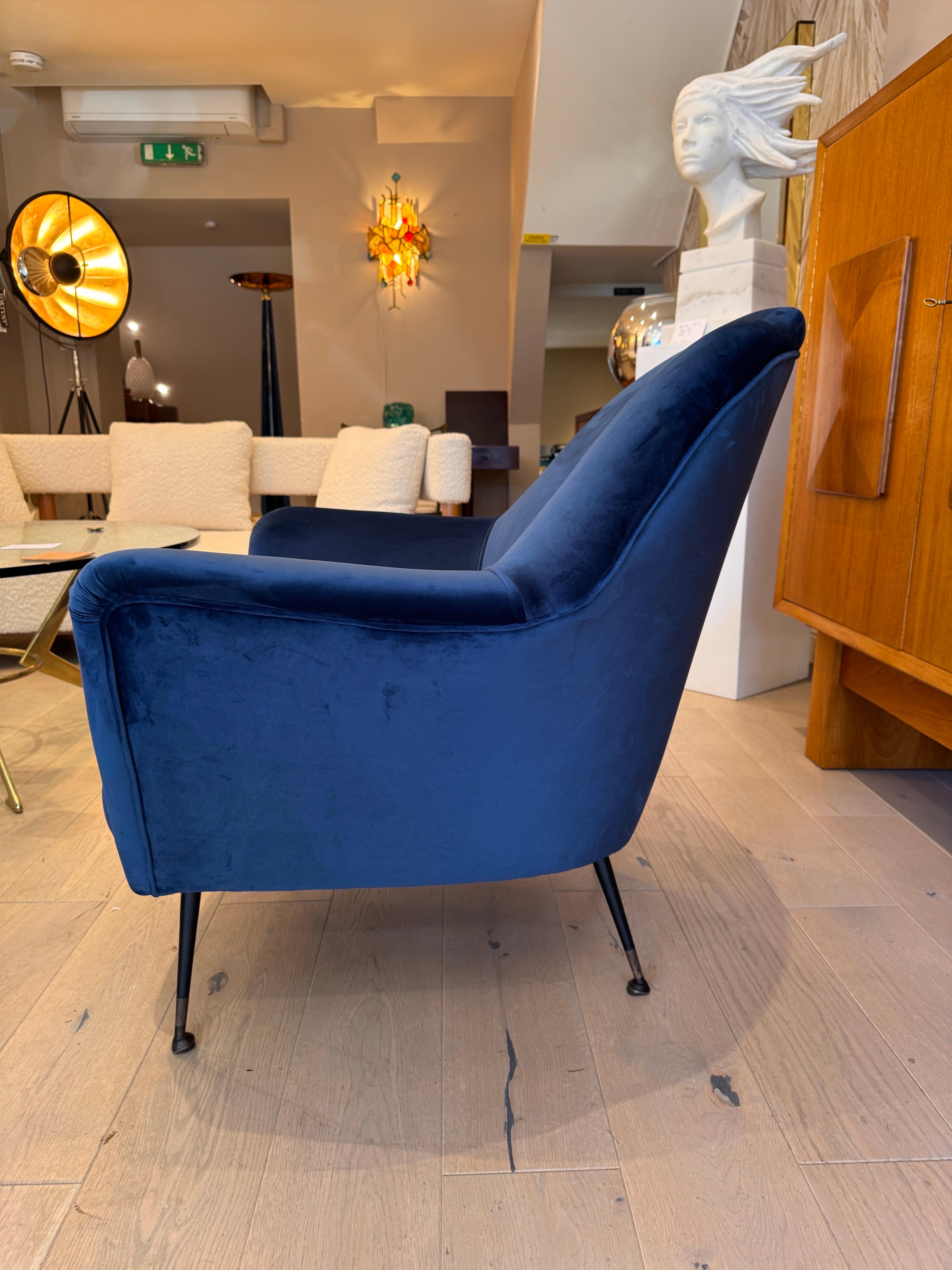 A fine pair of Italian armchairs standing on black metal legs with brass sabots , newly sprung & upholstered in lush blue velvet . Designed & produced by ISA Bergamo C1950 Italy 