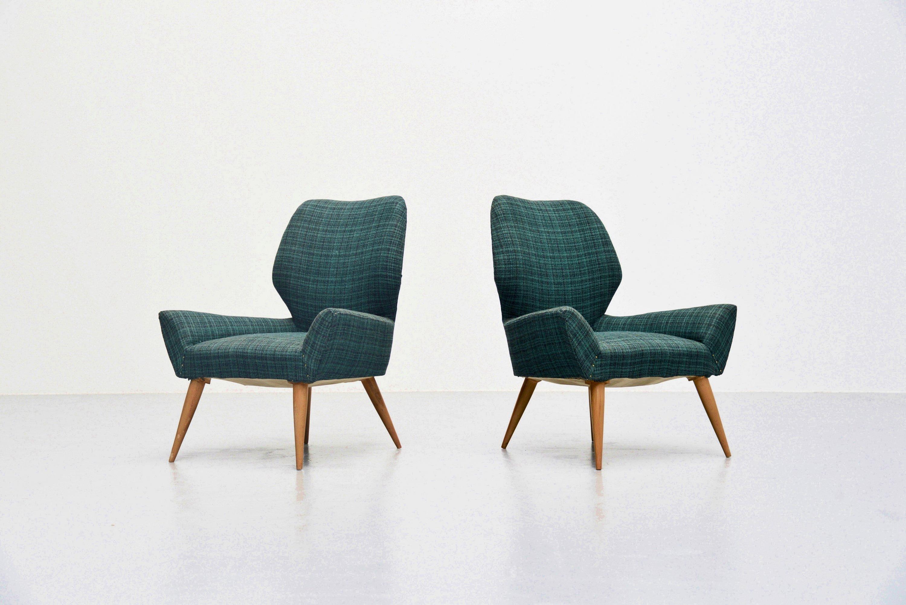 Very nice sculptural pair of low club chairs manufactured by Isa Bergamo, Italy, 1950. The chairs have beech wooden legs and still have the original green checkered upholstery which is still in nice condition. Of course this can be changed by our