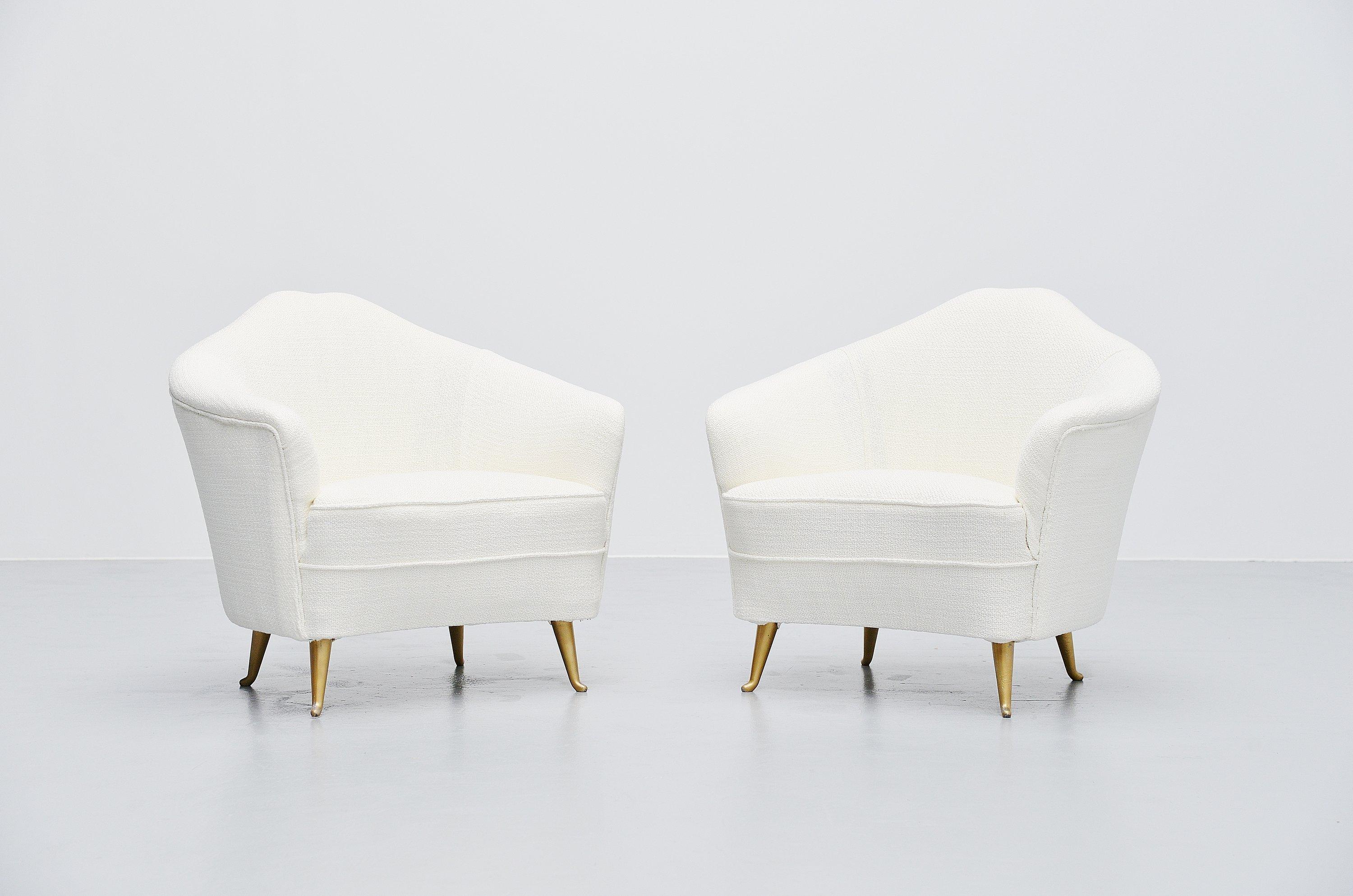 Small pair of club chairs designed and manufactured by Isa Bergamo, Italy 1950. This nice curved chairs are newly upholstered in white fabric upholstery and have cast aluminium legs which are gold painted. The small chairs have a very nice organic