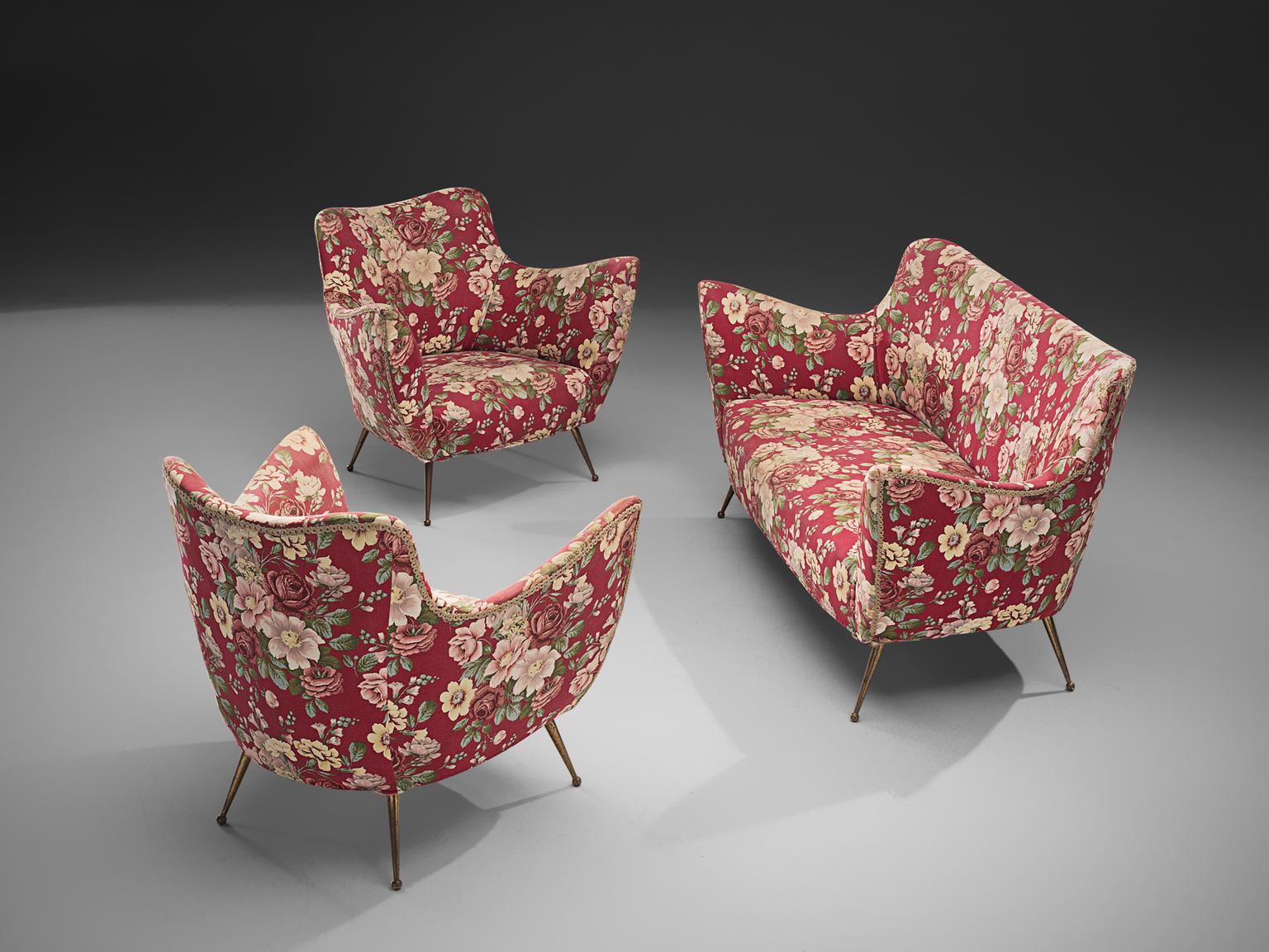 ISA Bergamo, lounge set, floral pink and red fabric, brass, Italy, 1950s. 

This set is an iconic example of Italian design from the 1950s. Organic and sculptural, this two-seat sofa and two matching lounge chairs are anything but minimalistic.