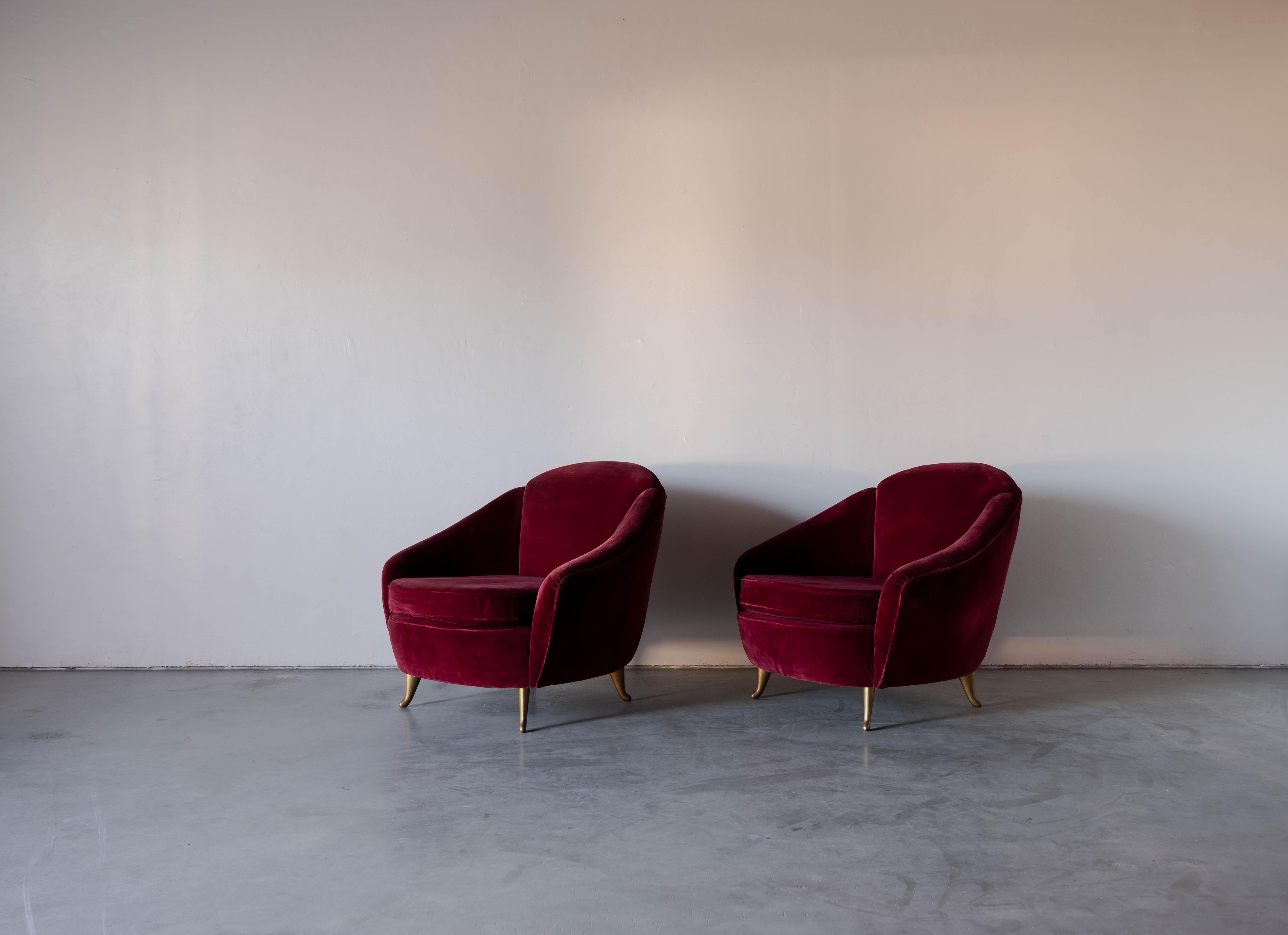 A pair of brass and velvet lounge chairs produced by ISA Bergamo, Italy, c. 1952.

With makers metal plaque to underside.