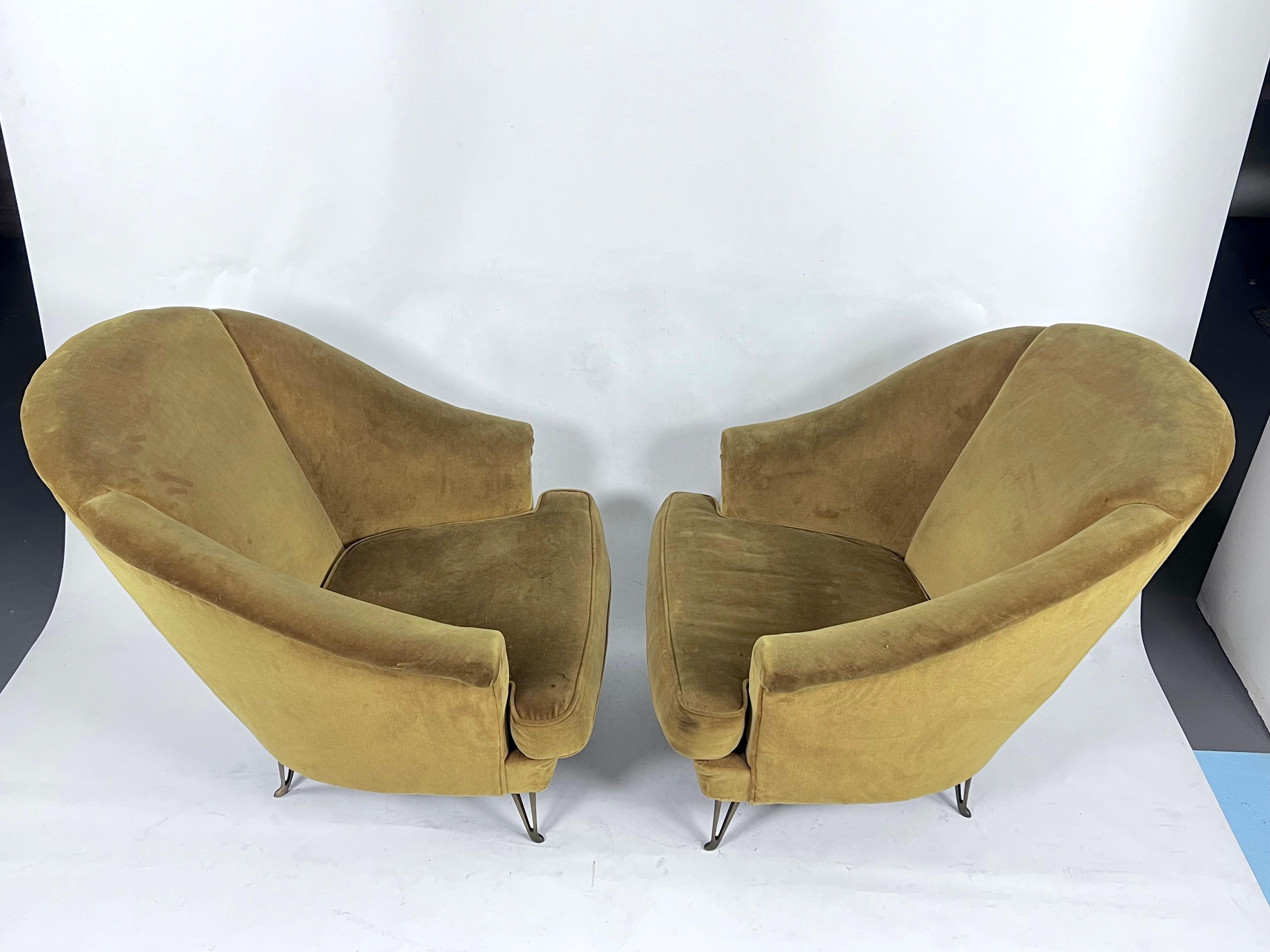 Rare pair of Labeled Isa Bergamo armchairs with original velvet and unaltered vintage condition with normal trace of age and use. Designed in the style of Gio Ponti, there are the manufacturing labels. To be noticed the rare metal tapered legs and