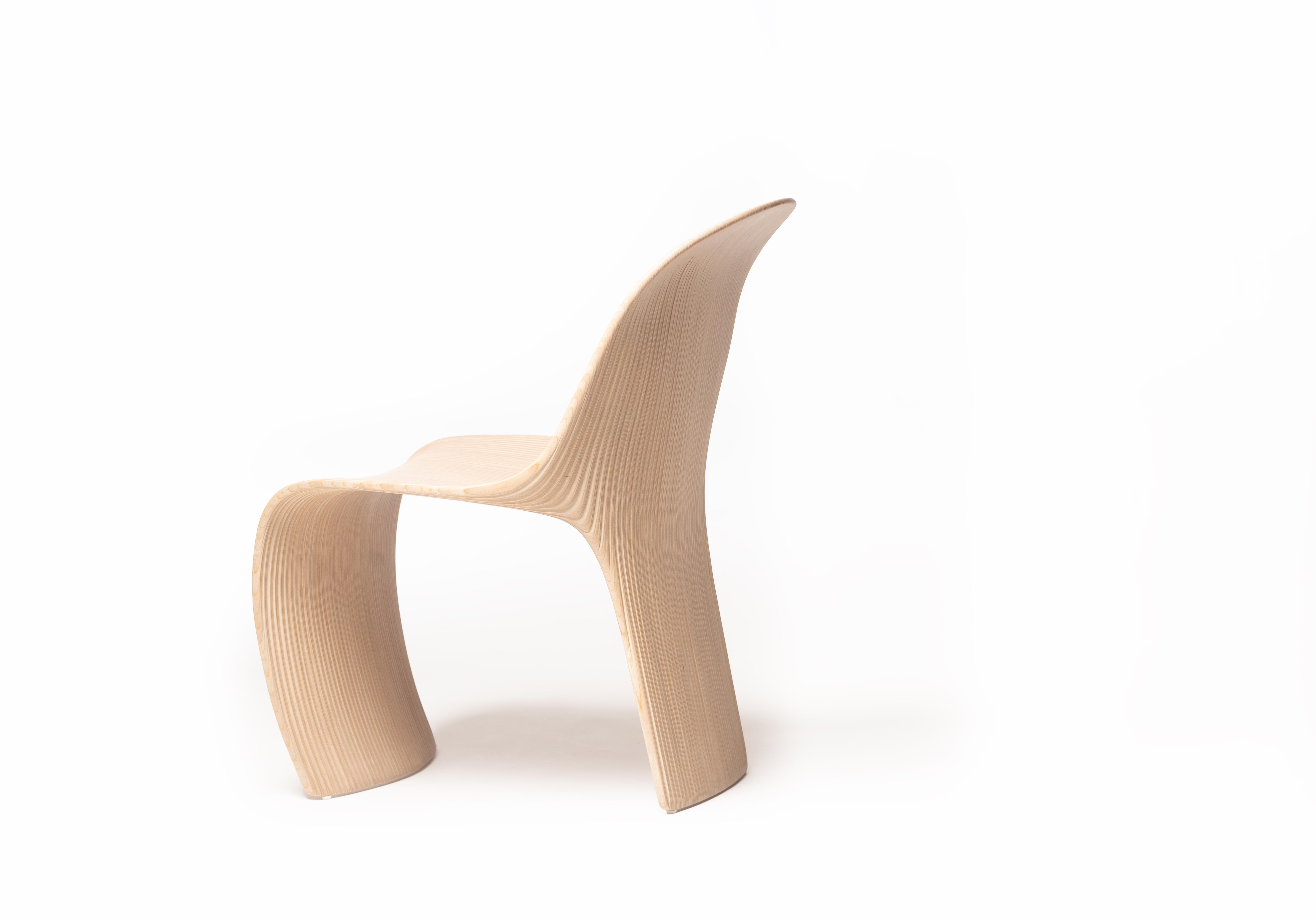 The Isa Dining Chair is a strikingly unique piece, crafted with an exceptional design that emphasizes both form and function. Made from 54 vertical sections of laminated birch and spruce wood, the chair boasts a modern and minimalist aesthetic that
