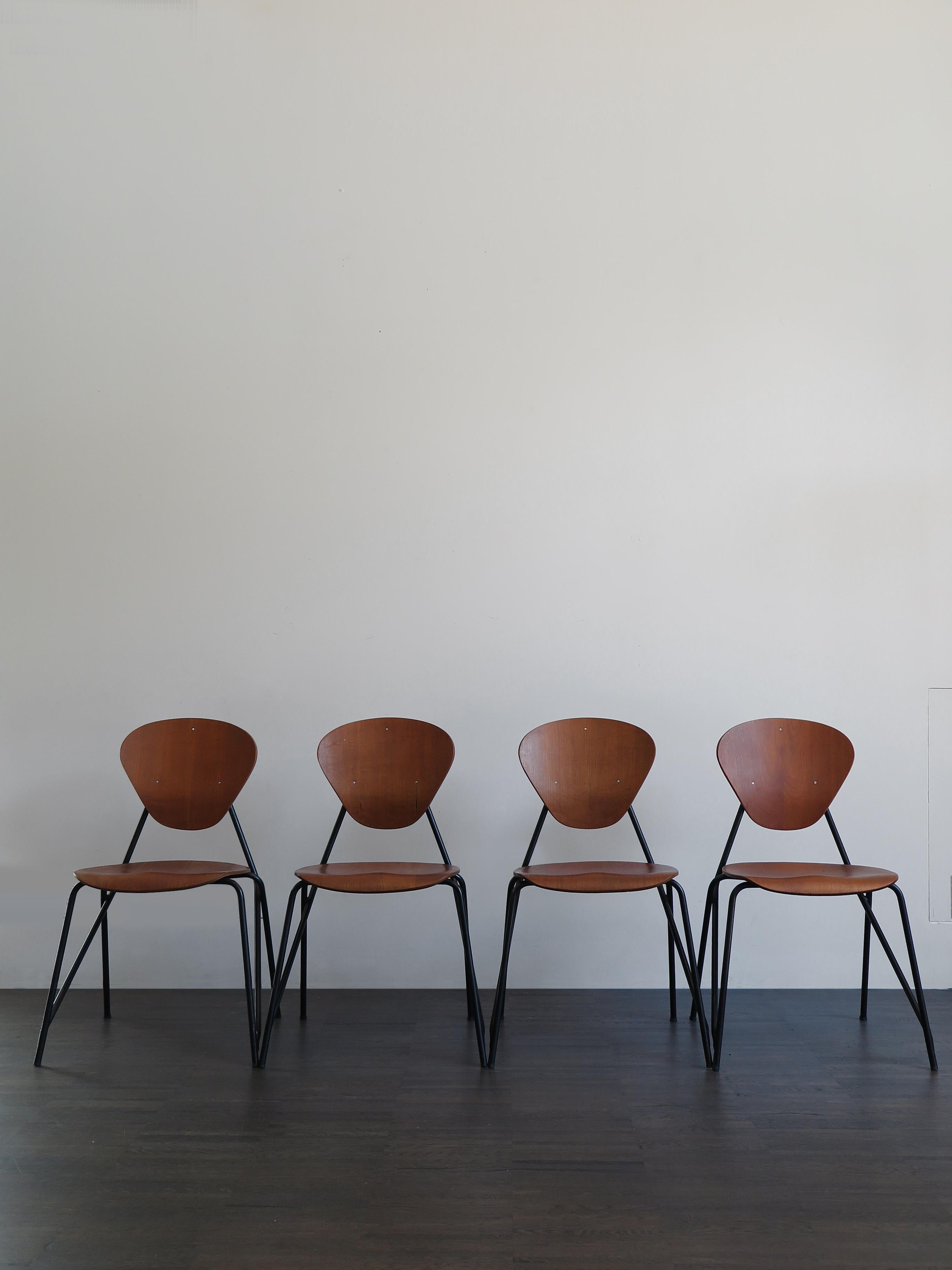 Set of four italian Mid-Century Modern design stackable dining chairs, shaped and curved teak plated plywood and structure in painted tubular steel, produced by Isa from 1960, original label of the ISA.

Please note that the chairs are original of