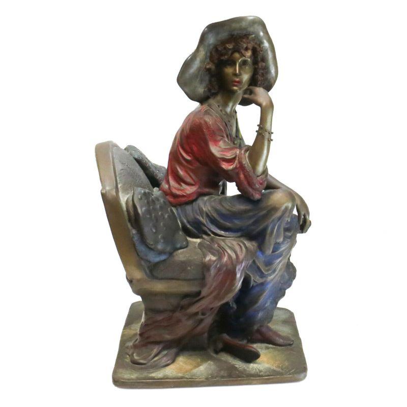 Isaac Maimon cold painted bronze sculpture seated woman

The sculpture beautifully depicts a beauty sitting on a chair with her right hand resting underneath her chin. Charming pops of color sparingly throughout. Signed to the base and is a