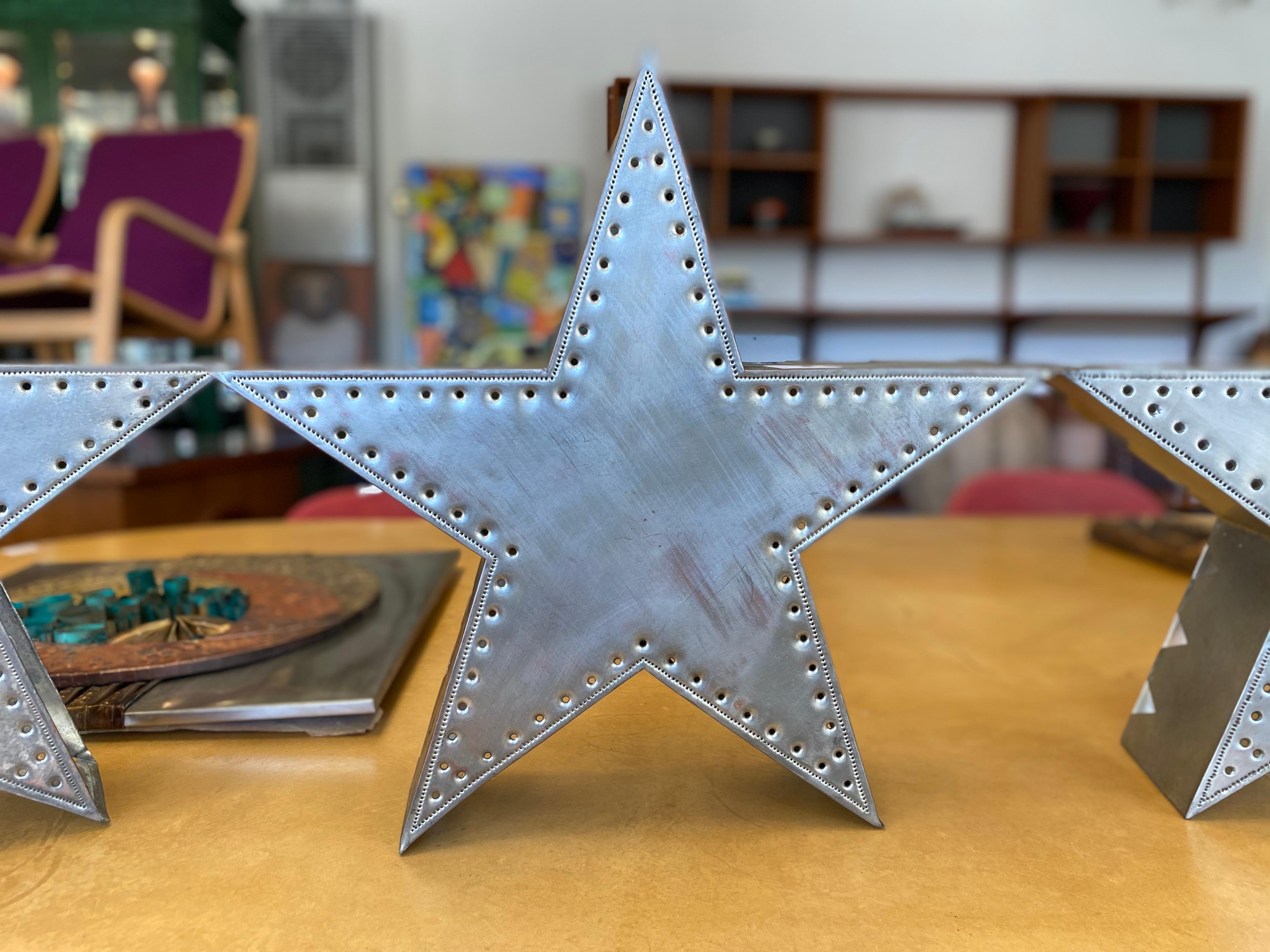 Beautiful architectural metal wall fixture designed by Isaac Maxwell Metal features a plated copper star pattern with punched holes that cast softly diffused light. Perfect for creating an ambiance. From Texas, Isaac Maxwell is known for his copper