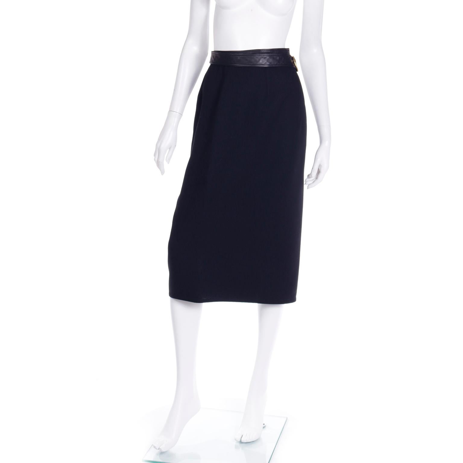 This is a beautiful vintage 1990's Isaac Mizrahi midi skirt in black wool with a black leather attached belt, The skirt is a wrap style and it creates an asymmetrical hemline when fastened. This is the kind of staple wardrobe piece that has so many