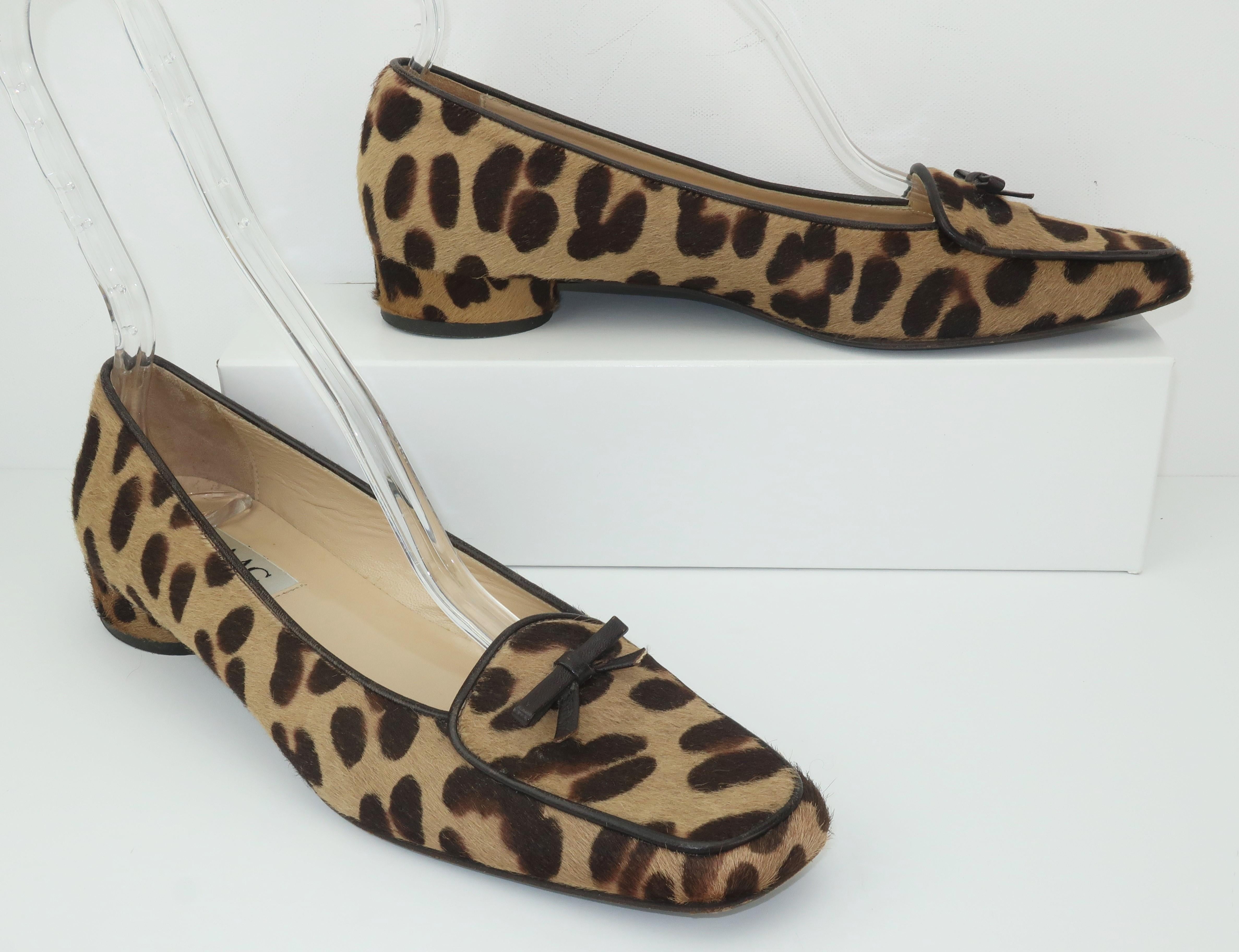 Isaac Mizrahi's take on the classic loafer includes an animal printed flat fur, brown leather bow detail and an elongated toe ... not to mention an adorable cylinder shaped heel!   Made in Italy and marked a size 7 1/2 M with light wear to leather