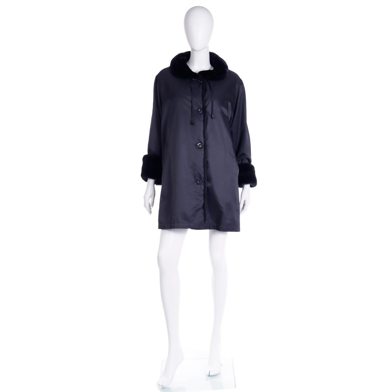 This vintage 1990's Isaac Mizrahi rain jacket is in a rich black with luxurious faux fur trim at the cuffs and neckline. Isaac Mizrahi designed some of the most versatile, timeless coats and they always had details that set them apart. We are