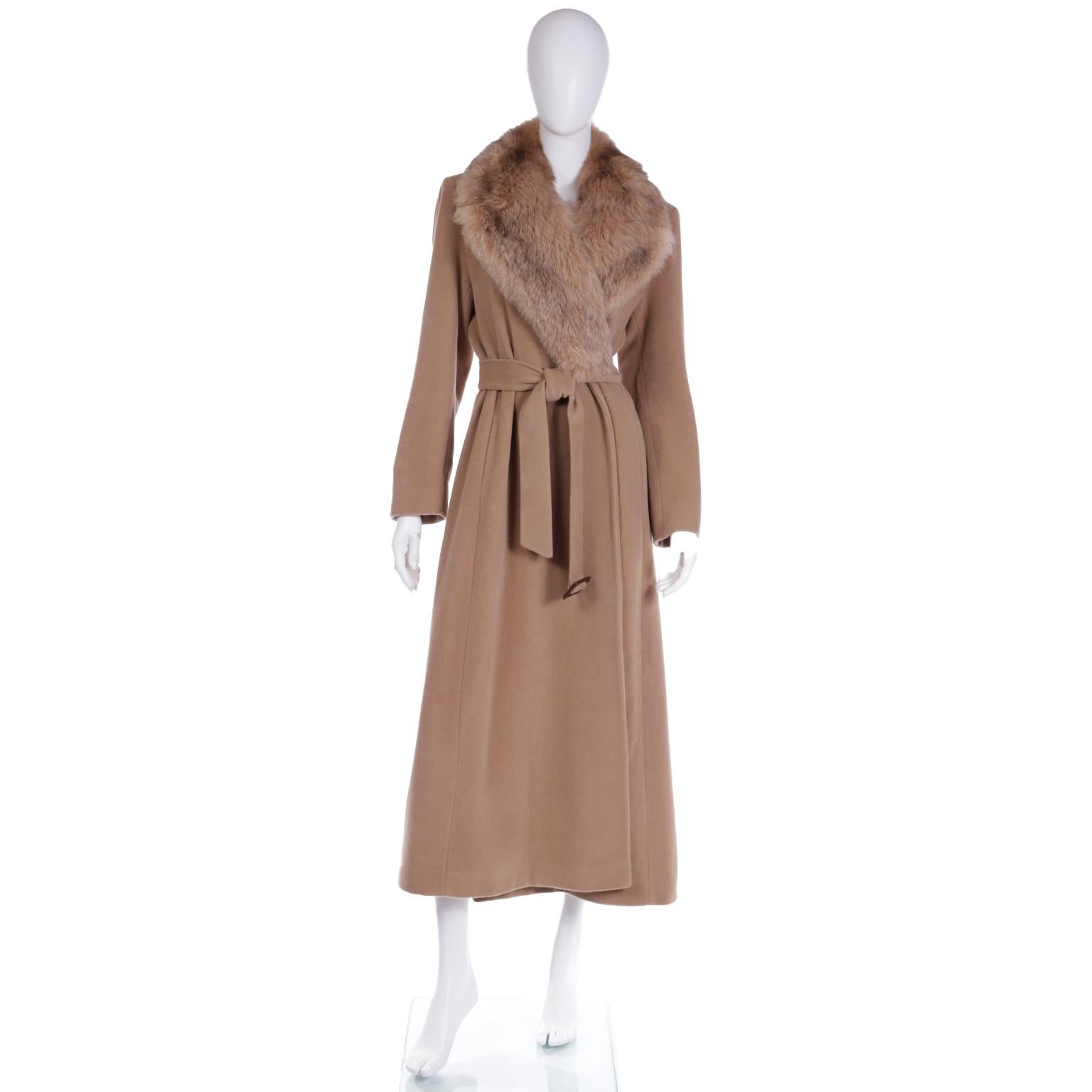 This ultra soft Isaac Mizrahi vintage 1990's camel brown coat has luxe fox fur lapels and a matching fabric belt with a leather belt buckle for closure. This superfine merino wool and angora blend coat has 2 slit pockets and shoulder pads for just