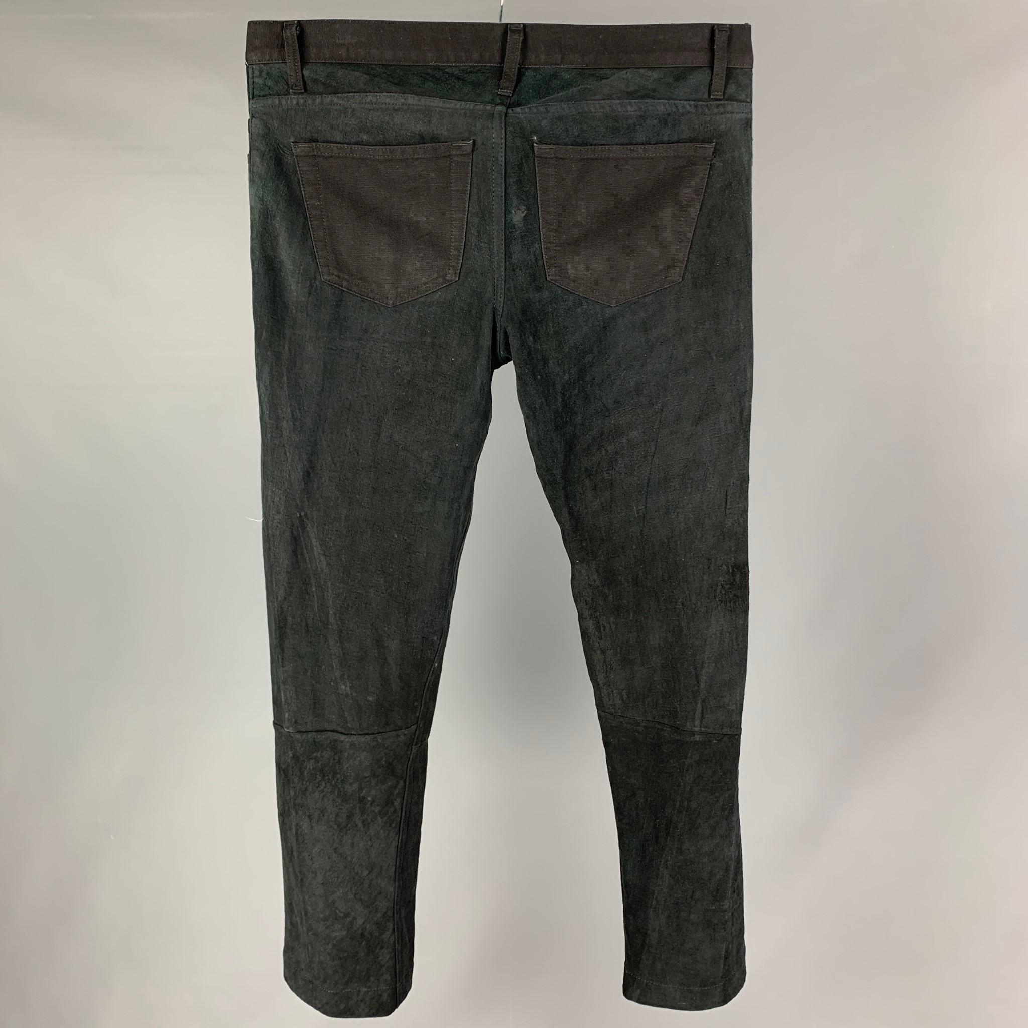 ISAAC SELLAM pants comes in a black suede with a canvas trim featuring a slim fit and a snap button fly closure. Made in France. 

Good Pre-Owned Condition.
Marked: 33

Measurements:

Waist: 36 in.
Rise:  10 in.
Inseam: 30 in. 

 